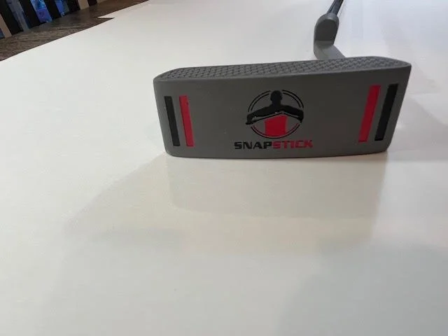 Snap Stick golf putter on white surface