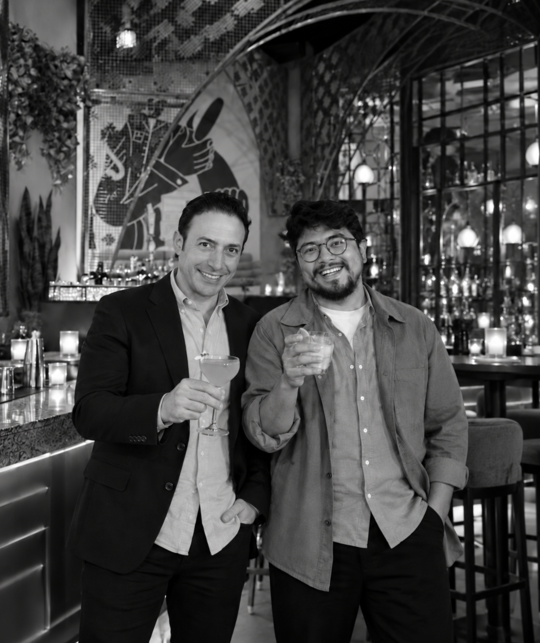 Momento co-founders Christopher Roldan and Cesar Fajardo holding cocktails inside Momento Cantina in Chicago.