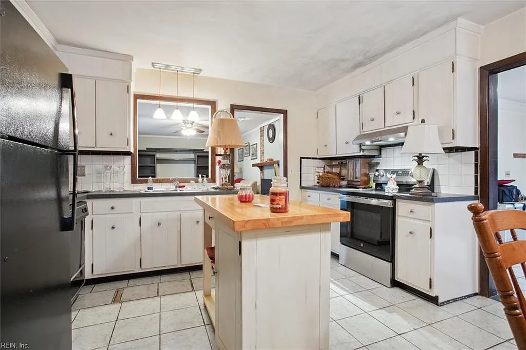 Updated kitchen with white shaker cabinets and wooden island, a JDK Strategic Solutions renovation project increasing property resale value.
