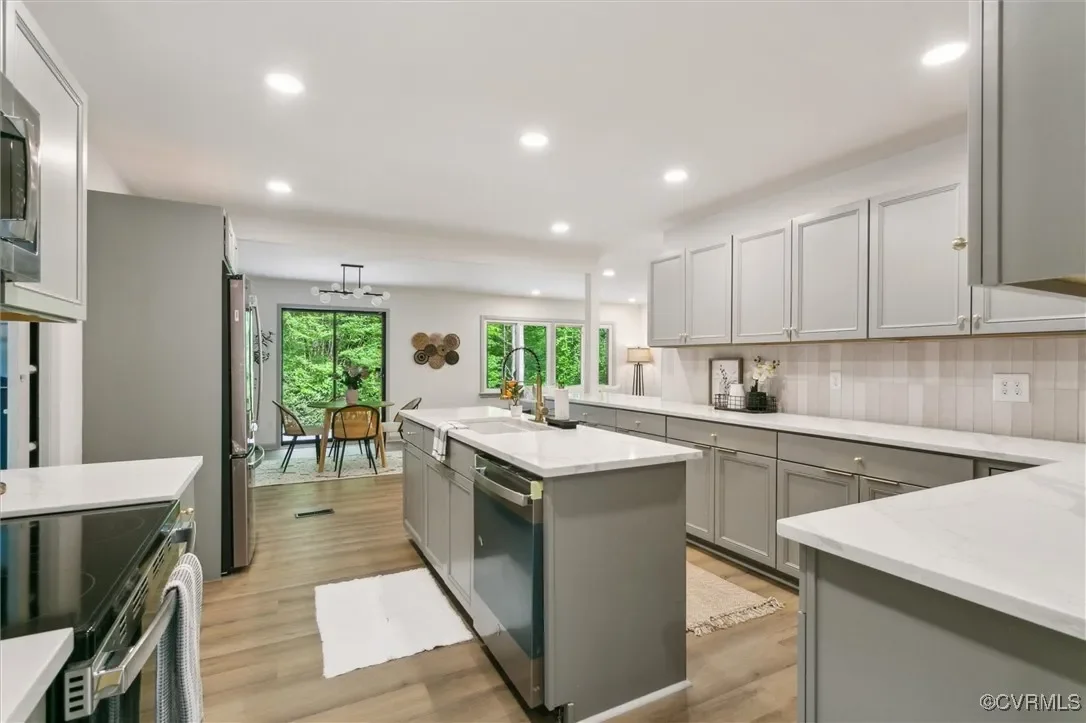 JDK Strategic Solutions kitchen remodel featuring contemporary gray cabinetry and stainless steel appliances, showcasing high-end investment property finishes.