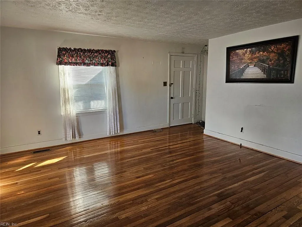 Investment property in original condition with hardwood floors, representing the type of homes JDK Strategic Solutions buys 'as-is' for cash.