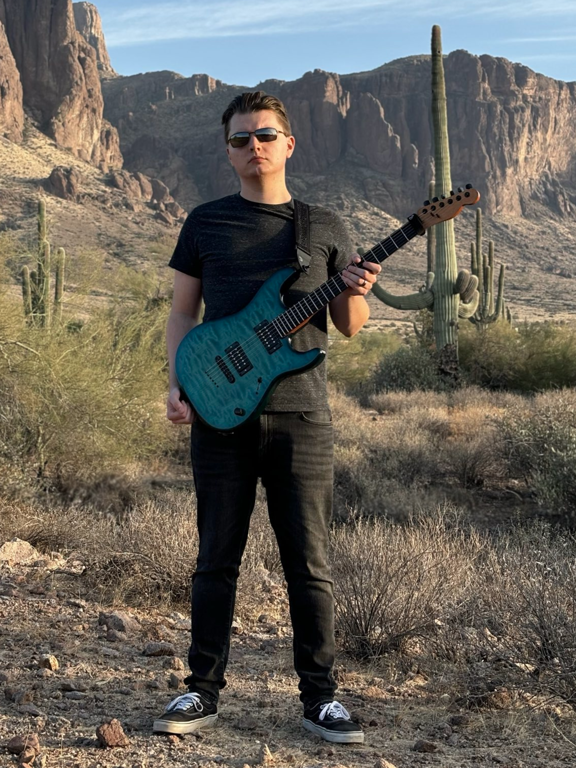 Connor in the Arizona desert with a custom-built Warmoth parts guitar.