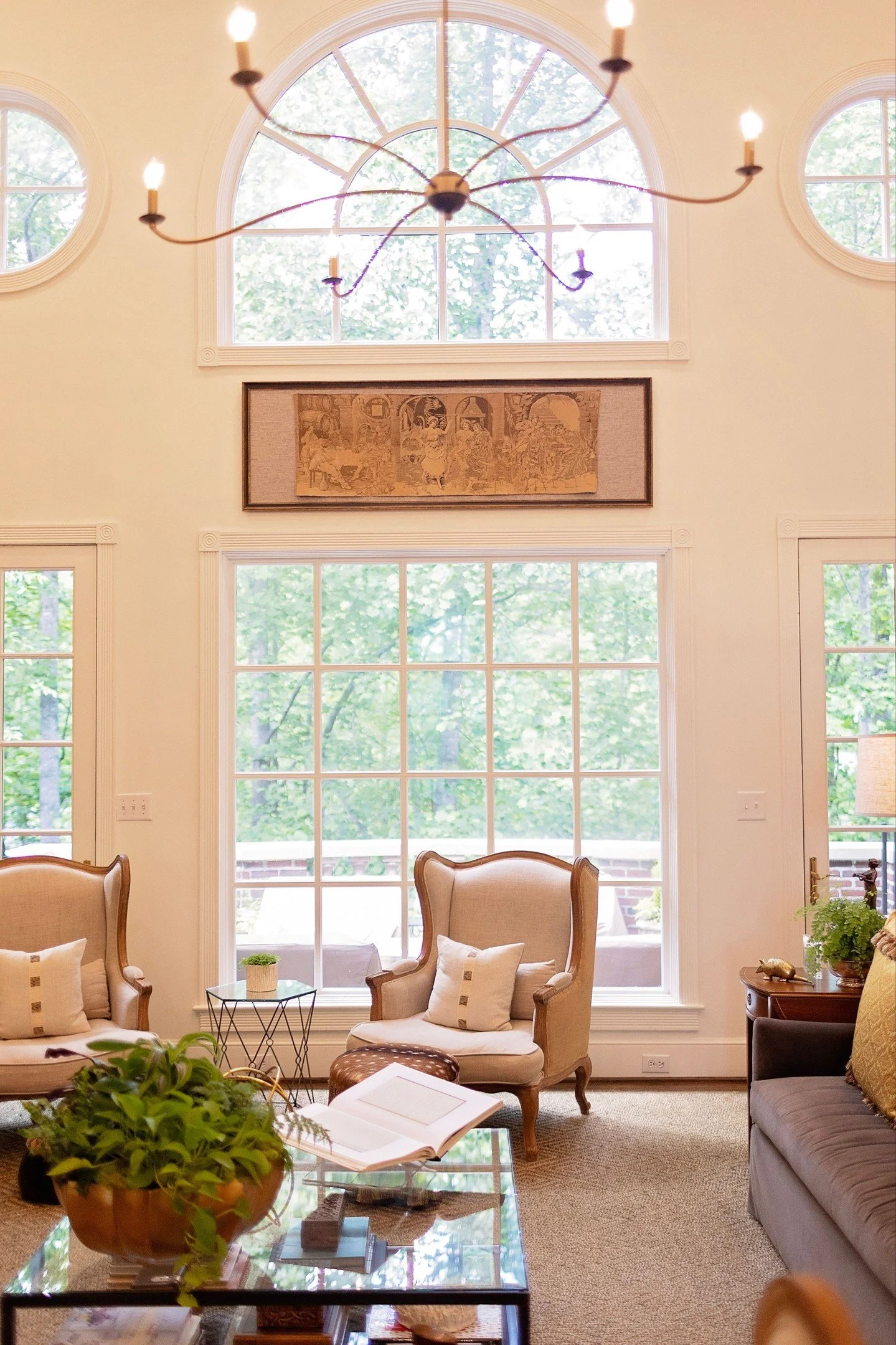Natural light has a way of transforming a space.

While the soaring windows were part of this home's original 1994 architecture, we embraced them by keeping the design light and timeless. Custom white paint enhances the natural light, creating a brig