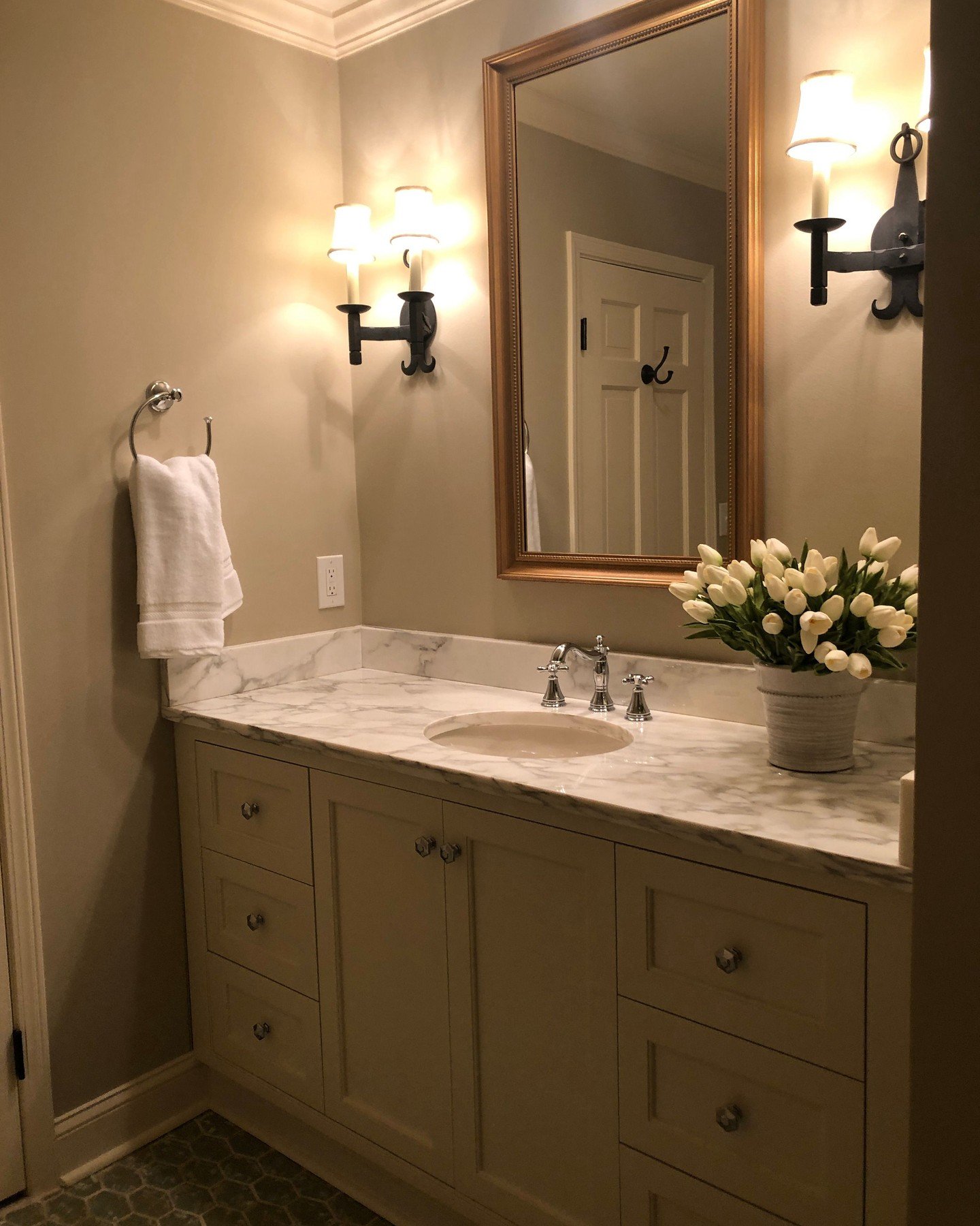 A full renovation isn't always necessary to make a bathroom feel new.

For this space, we kept the original floor tile while updating the shower, countertop, paint, plumbing fixtures, lighting, and finishing details.

Chrome is a timeless finish that