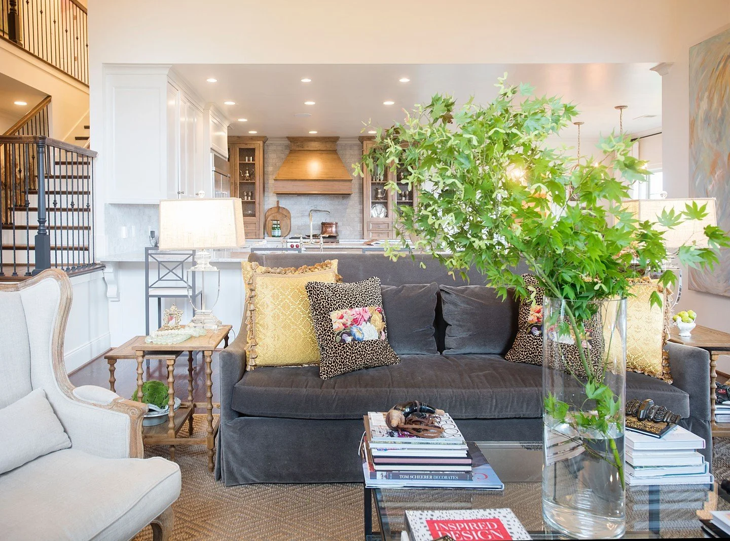 Large open floor plans can sometimes feel challenging to make cohesive and cozy.

This space successfully pulls it all together through layers of personality, depth, and thoughtful details. Original and commissioned artwork, custom pillows, stacks of