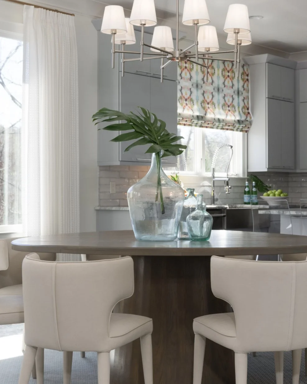 Custom drapery and a motorized Roman shade bring the color in here, and this client loves both color and entertaining. Add the saltwater pool just outside, and it feels like a little vacation. The doc will even whip you up a drink of choice, so it's 