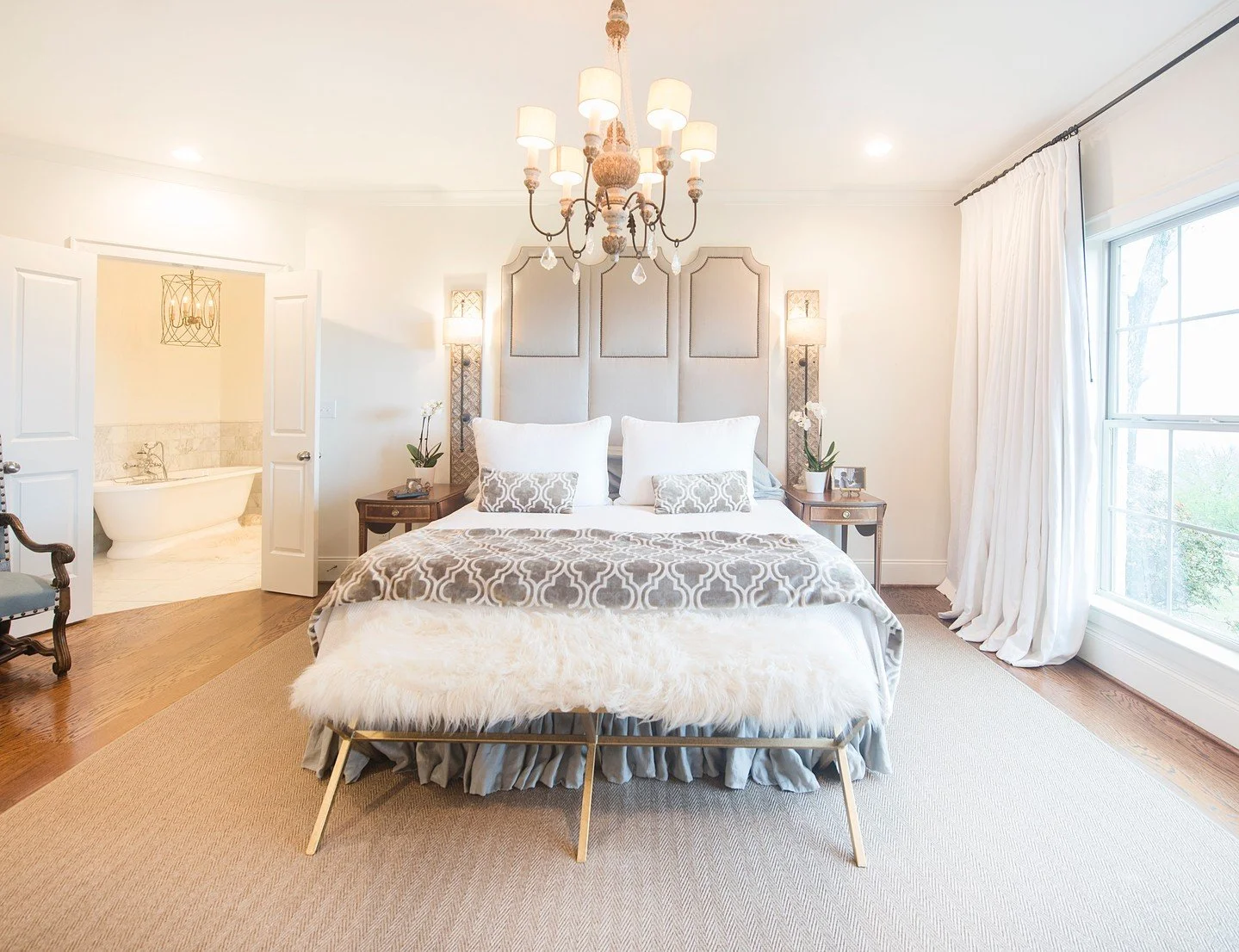 Custom drapery and hardware, a custom headboard, and custom bedding set the tone for this serene bedroom. Soft layers and a little shine keep it feeling elevated, but still easy to relax in. 🤍

The side tables are inherited pieces, which give the ro