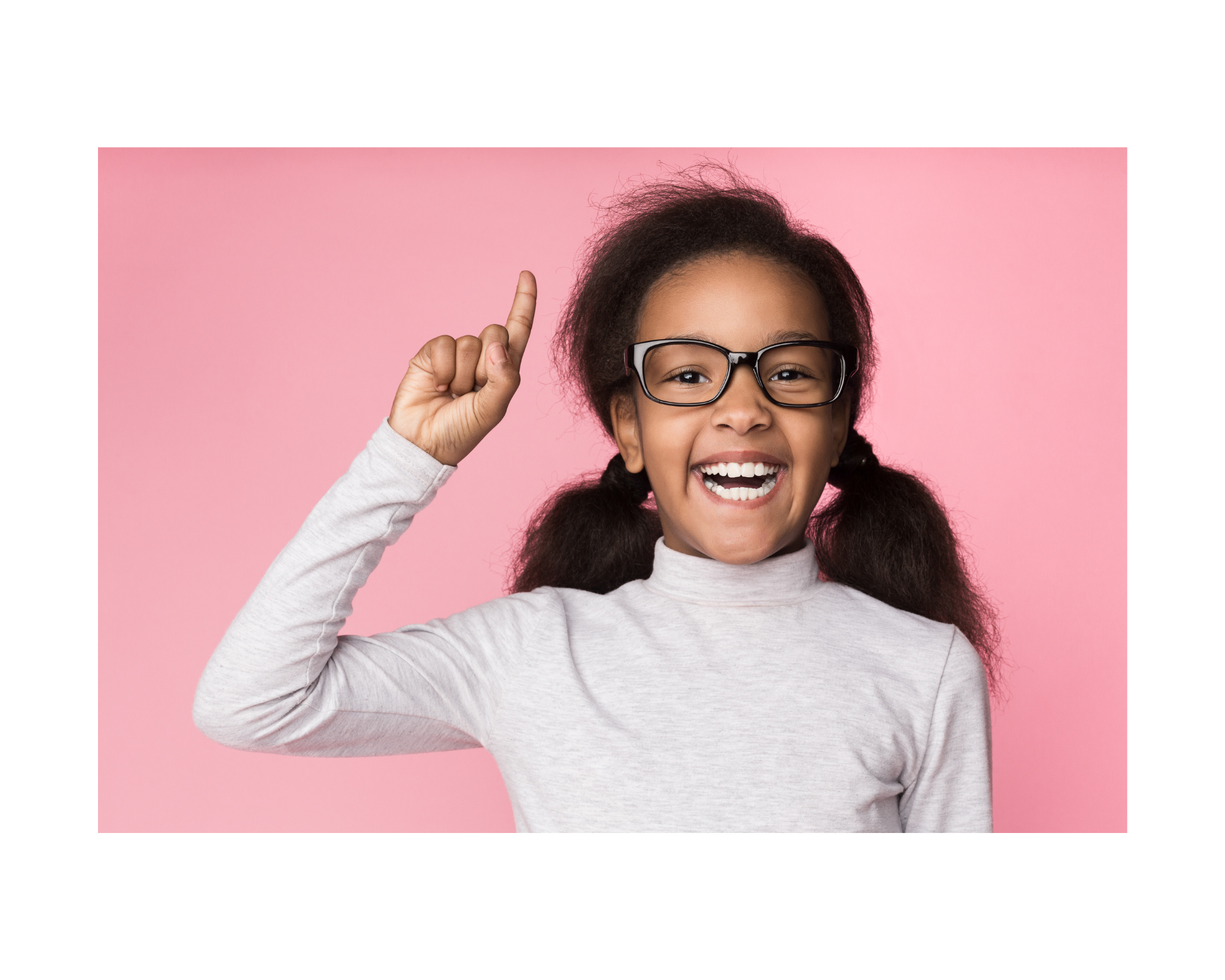 A young girl with hand pointing up and big smile on her face.
