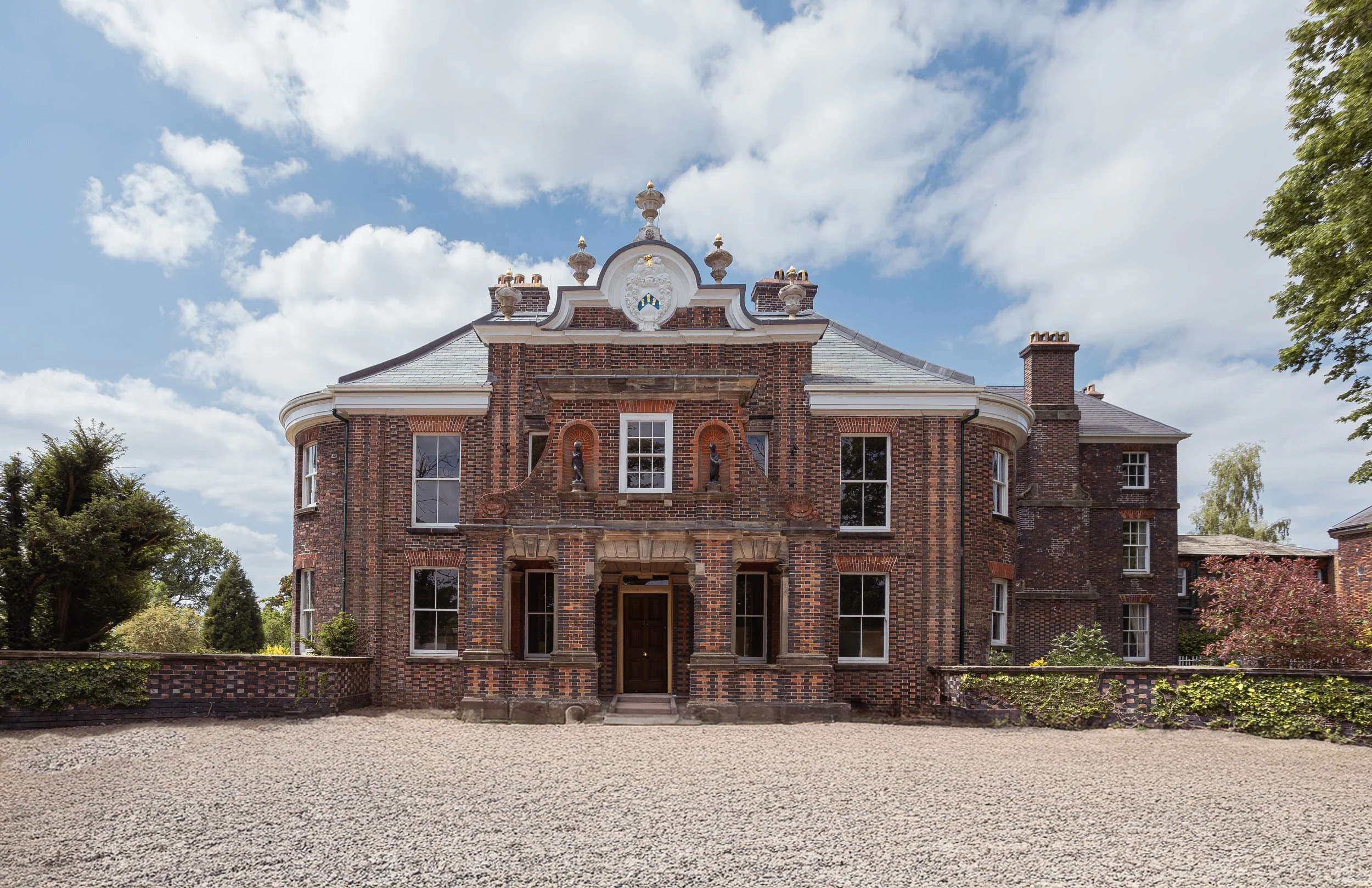 Luxury Georgian manor house exterior at Betley Court Staffordshire holiday rental with manicured grounds