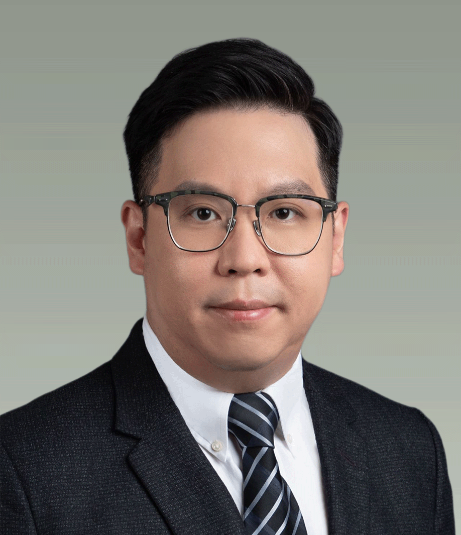 Portrait of a man wearing glasses, a dark suit, and a striped tie, with a light green background.