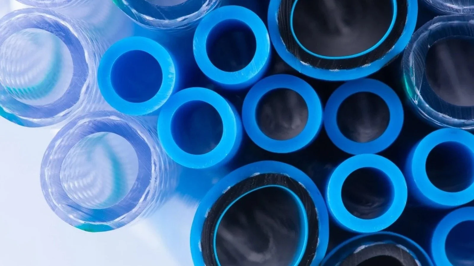 Blue and transparent industrial tubing viewed from the open ends