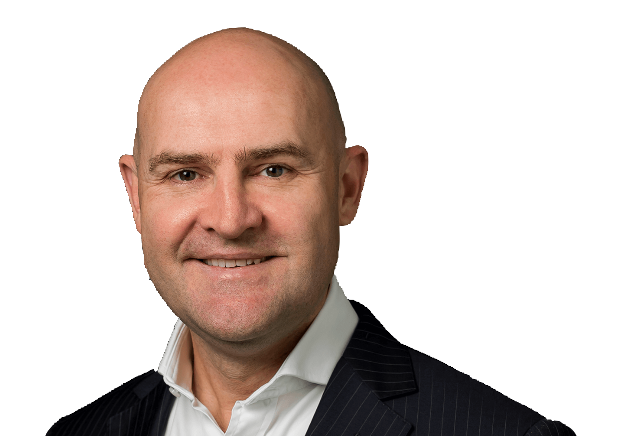 A professional headshot of a smiling bald man in a suit and white shirt.