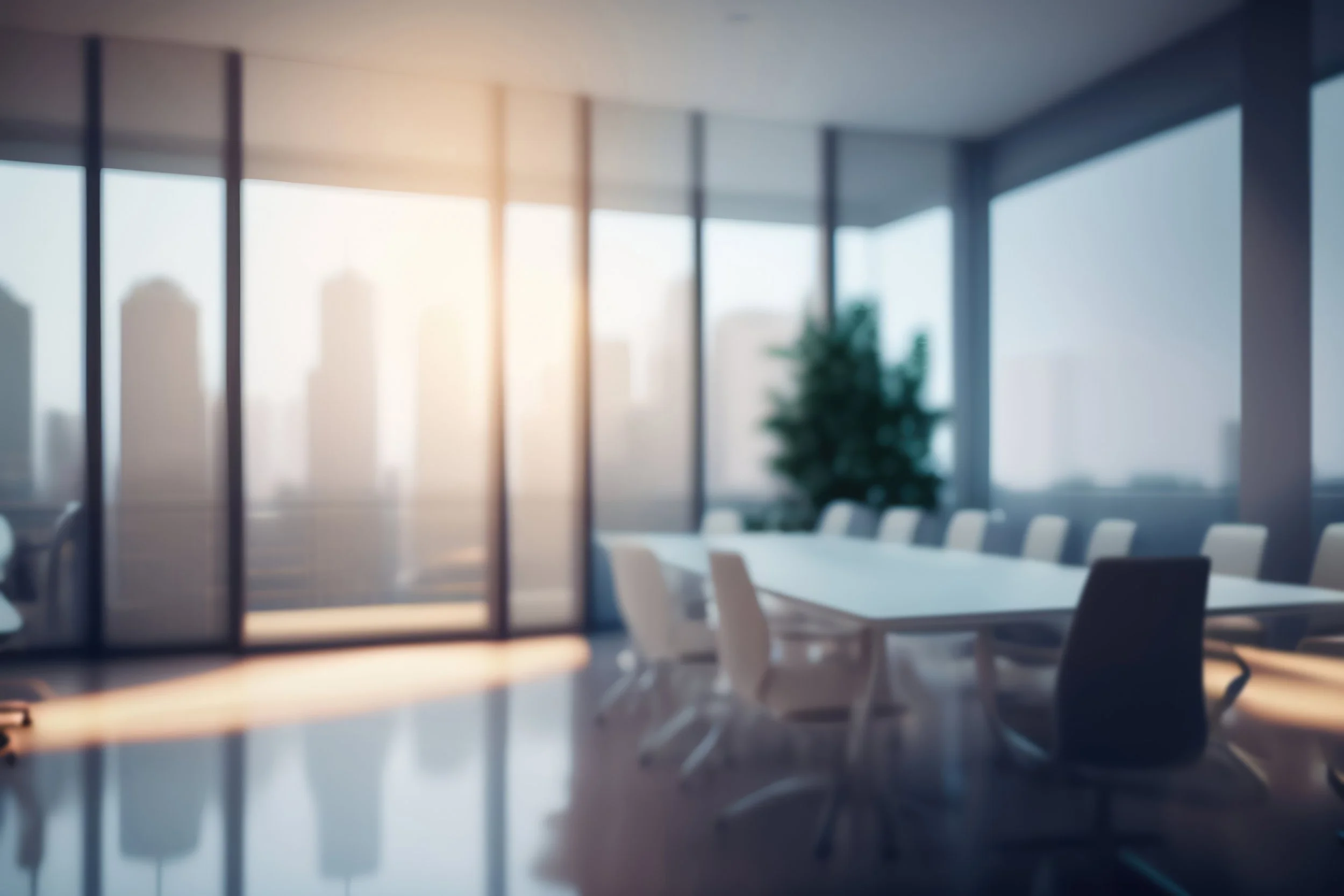 A modern conference room with a long table and white chairs, large windows with city skyline view, and sunlight streaming in.