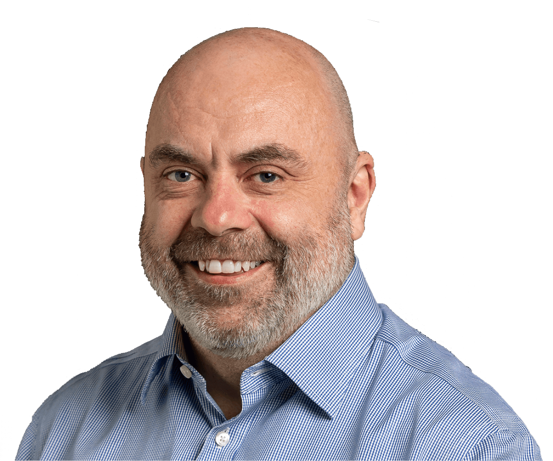 Close-up portrait of a smiling bald man with a beard, wearing a light blue dress shirt.