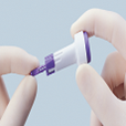 Close-up of gloved hands holding a medical lancet