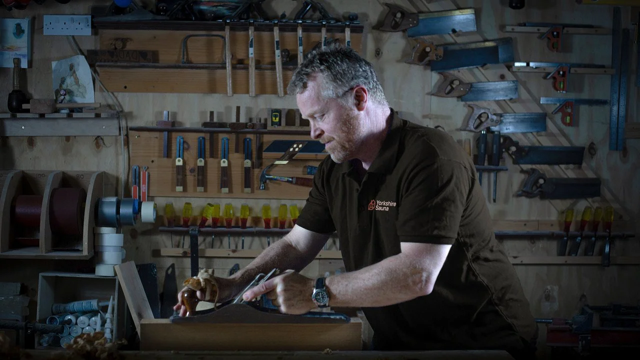 Matercraftsman Kevin Lordan handcrafting a custom-made Yorkshire Sauna in the York workshop the York workshophand working on a custom made Yorkshire Sauna in the workshop in York.
