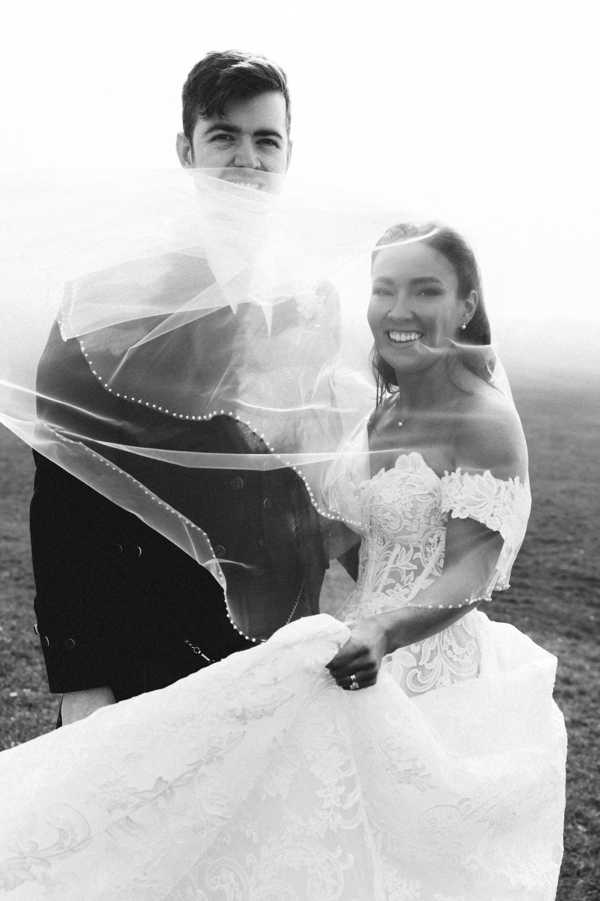 black and white image of a wedding couple from Ayr on haar foggy and windy day