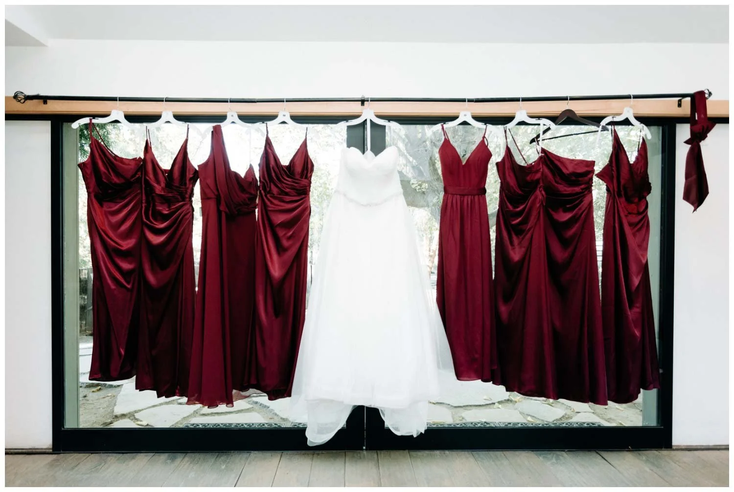 Bride and bridesmaids dresses detail photos hanging in the bridal suite in Galway Downs, CA