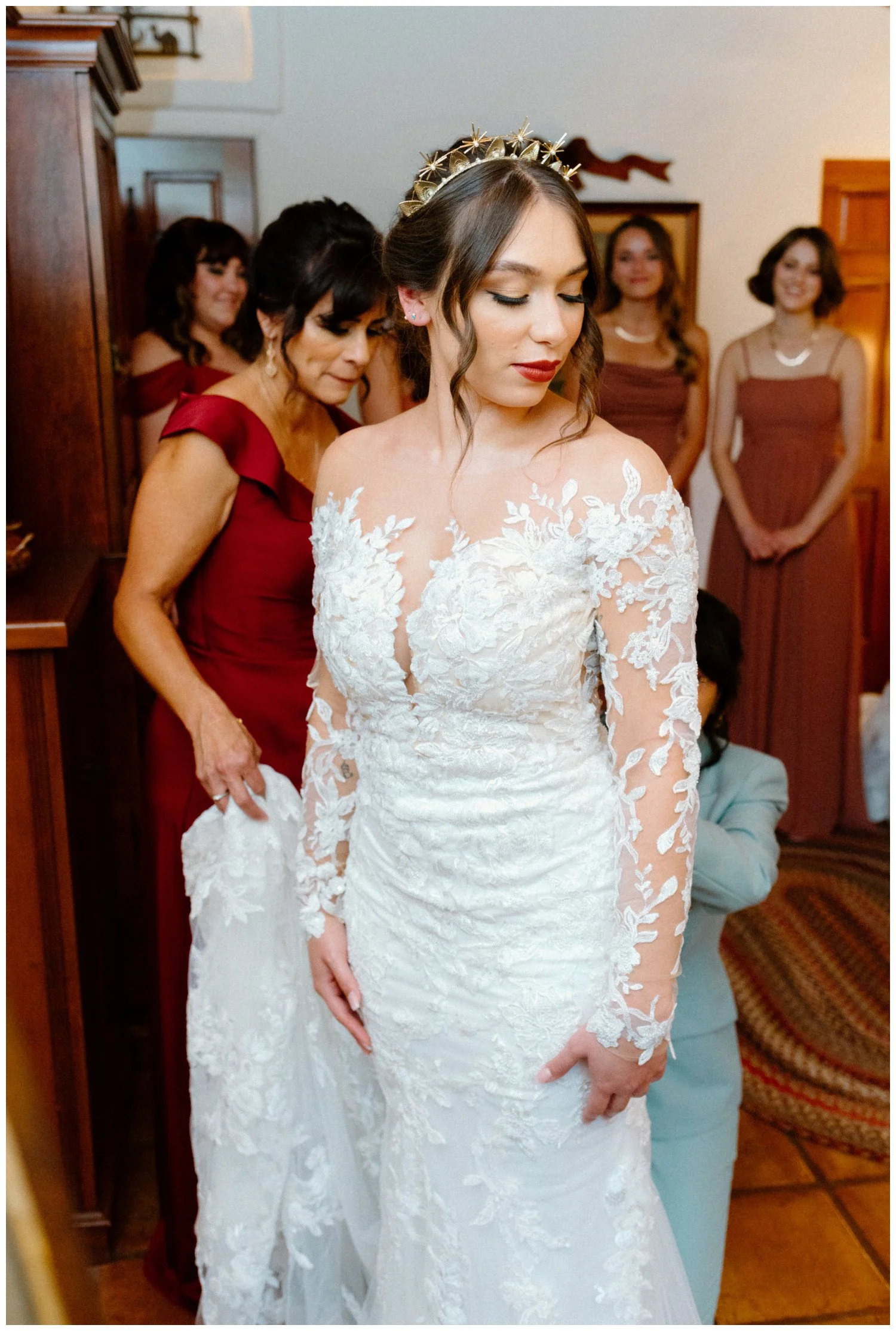 Bride's first look with bridesmaids, boho chic wedding with rust orange, old rose, and burgundy bridal party colors, candid wedding photography in the old rancho estate