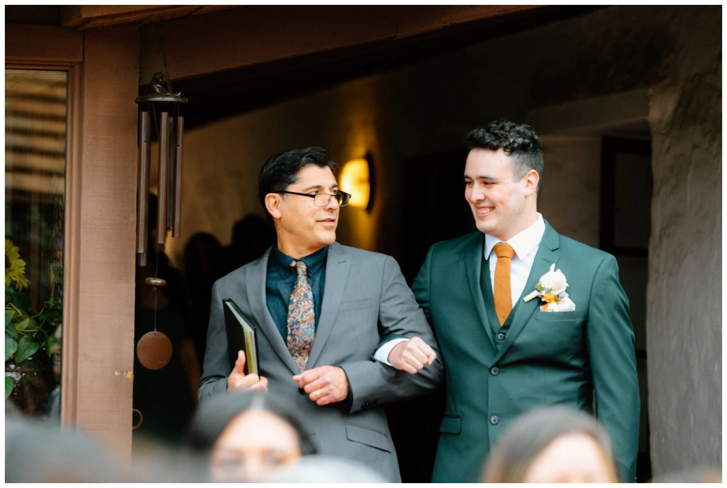 groom walks down the aisle with officiant