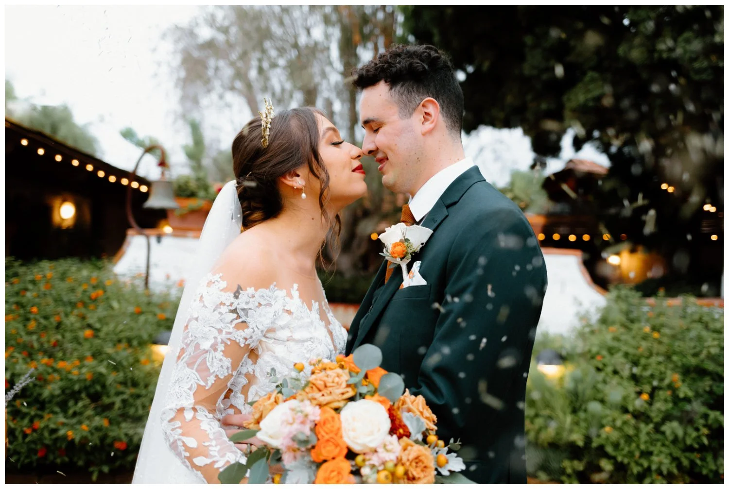 lavender petals in the air as bride and groom kiss, fun and editorial wedding photography at the old rancho carlsbad, california