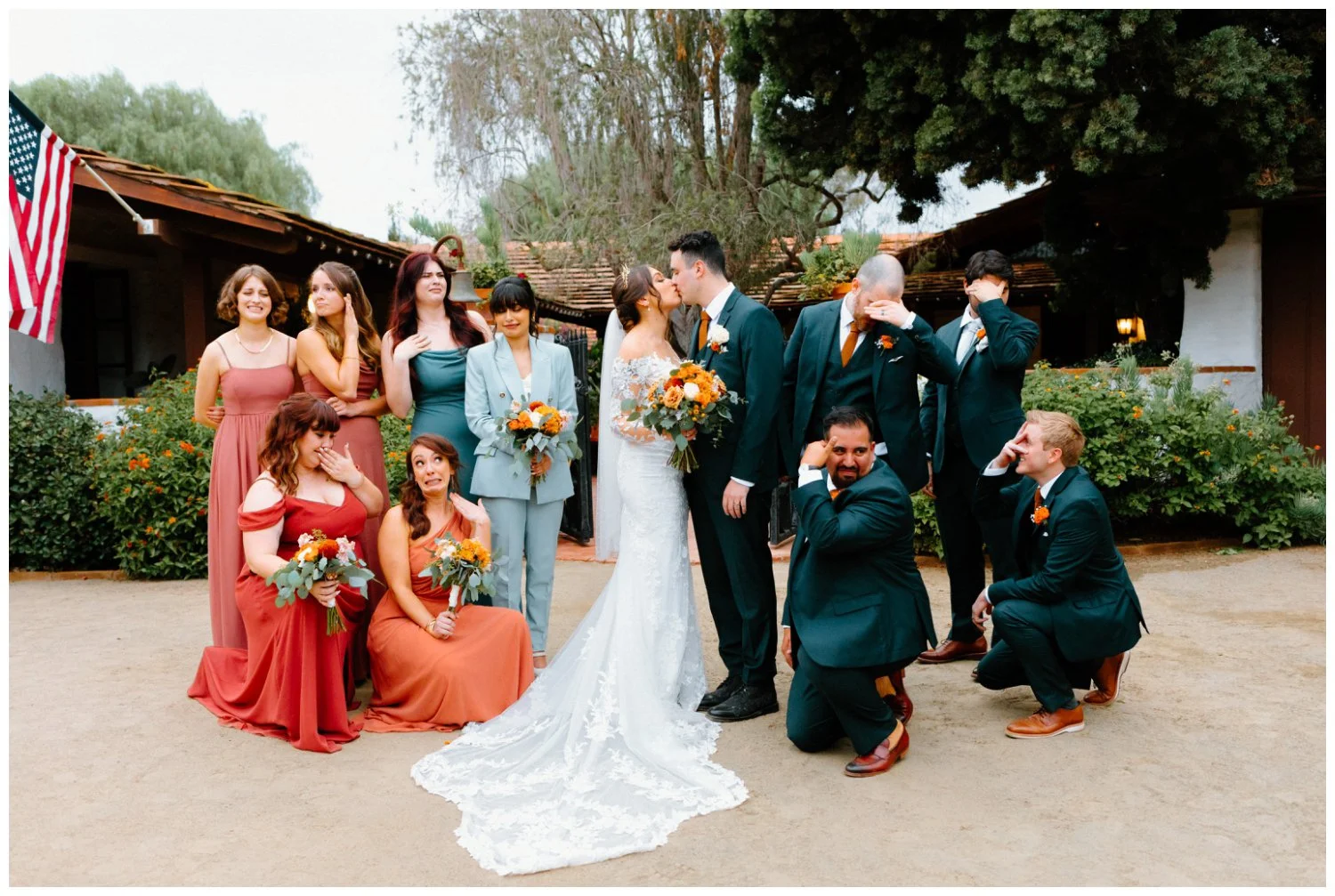 playful photo of bride and groom with the wedding party