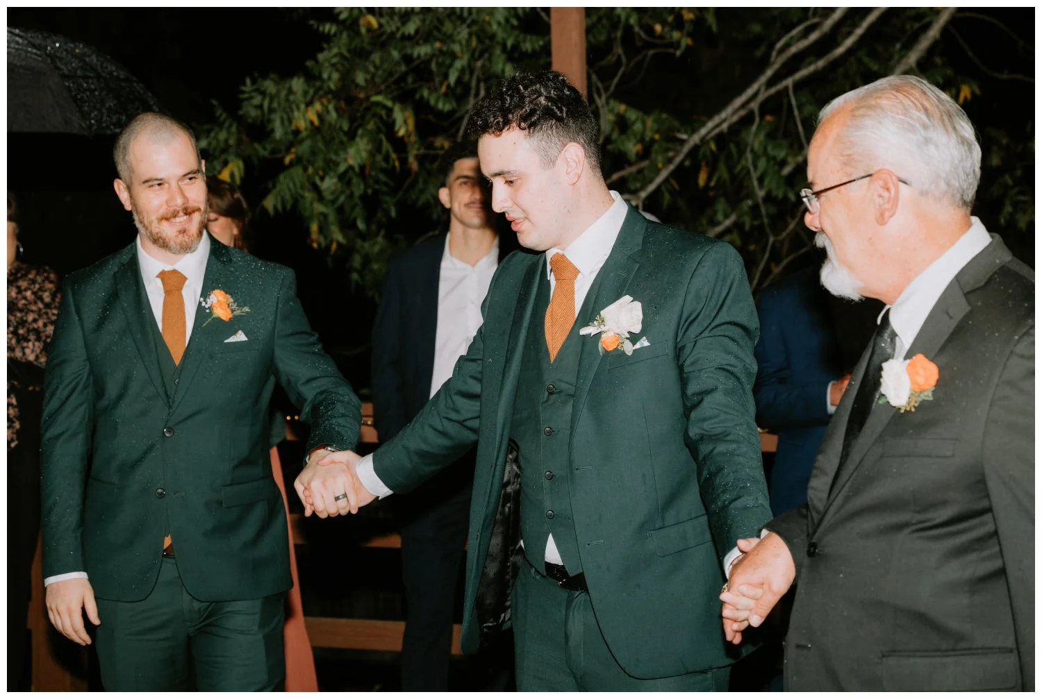 Groom dances with his brother and father for their family dance at the old rancho estate