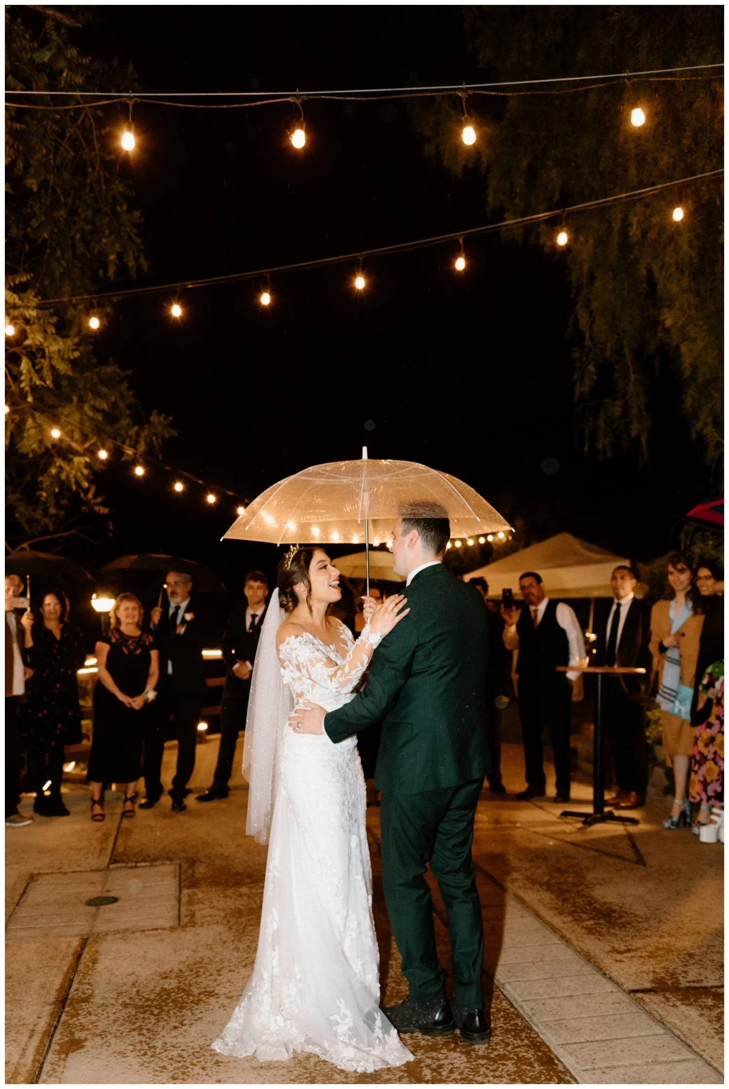 Bride and groom dancing in the rain at boho chic wedding reception Old Rancho Estate Carlsbad, editorial wedding photography