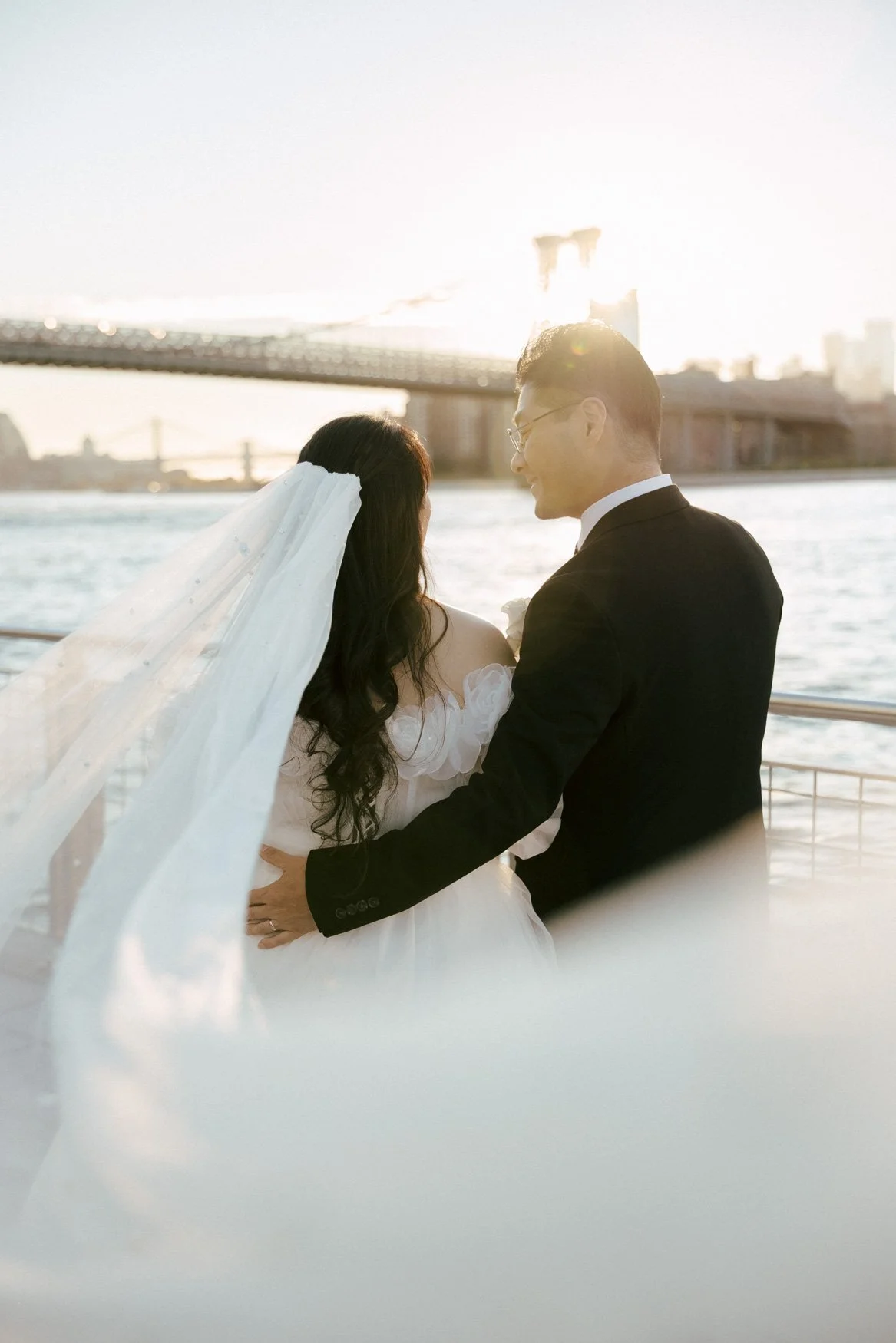 romantic veil photo of bride and groom in brooklyn bridge