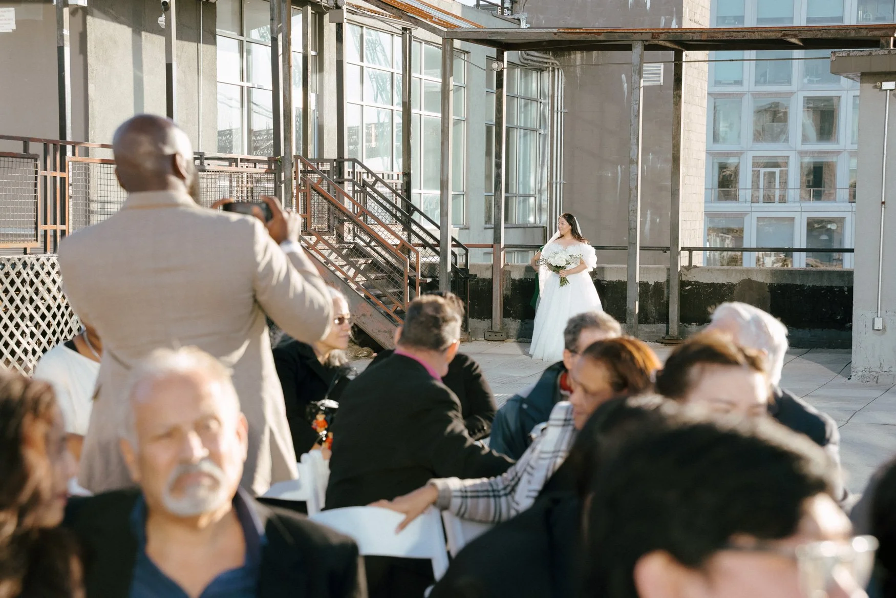 bride enters the ceremony site, sunset rooftop wedding in brooklyn, new york