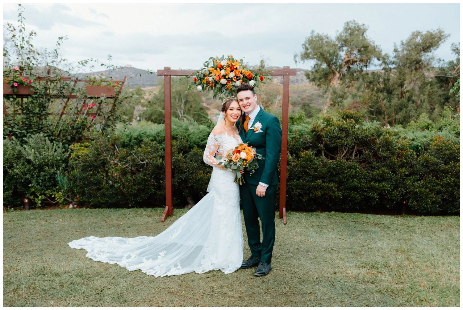 Belen and Ross by the ceremony arch as newlyweds, editorial and documentary wedding photography in san diego, california
