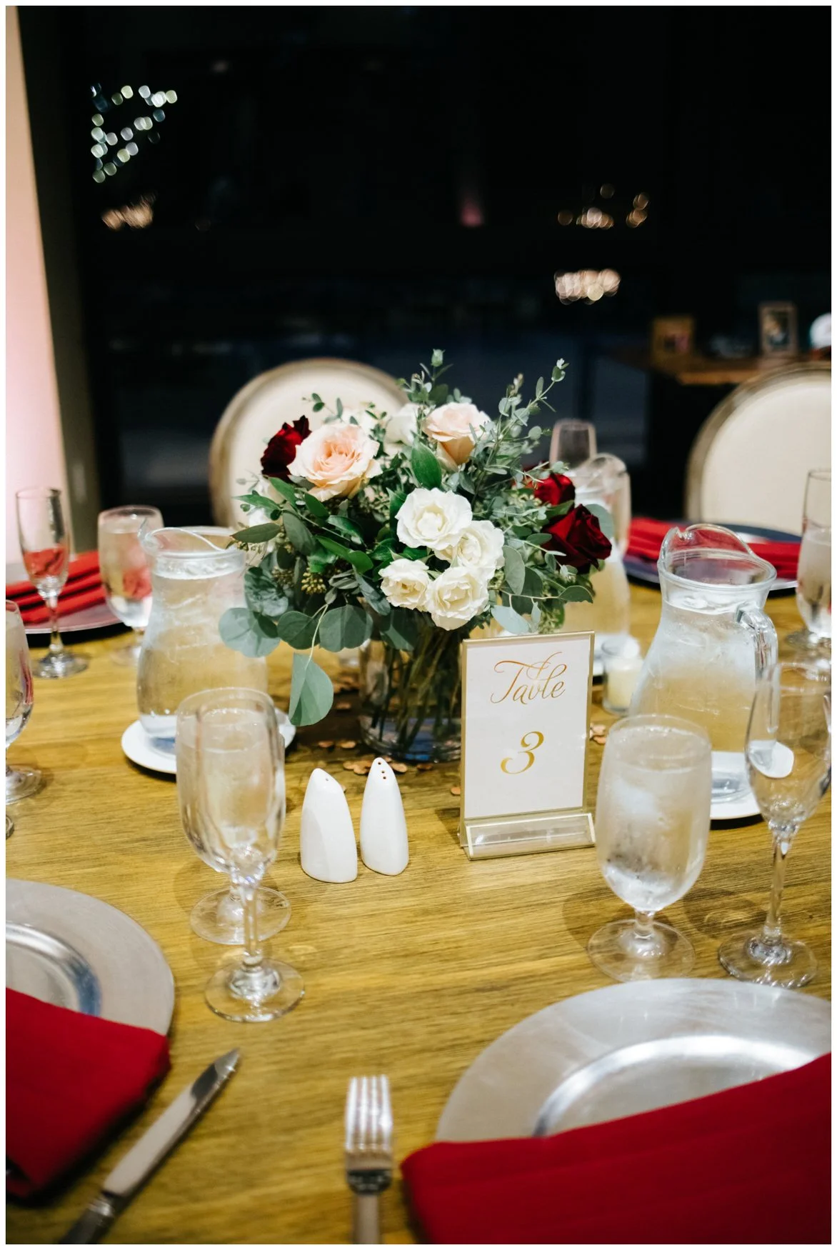 Red wedding accents with green, blush, and white color palette on a wedding tablescape in Temecula, California