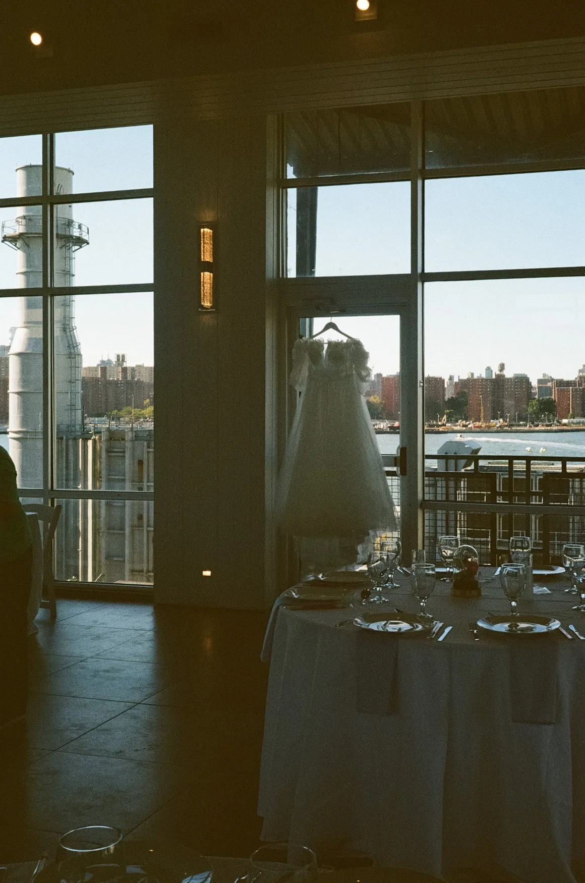 35mm film photo of dress hanging with manhattan skyline
