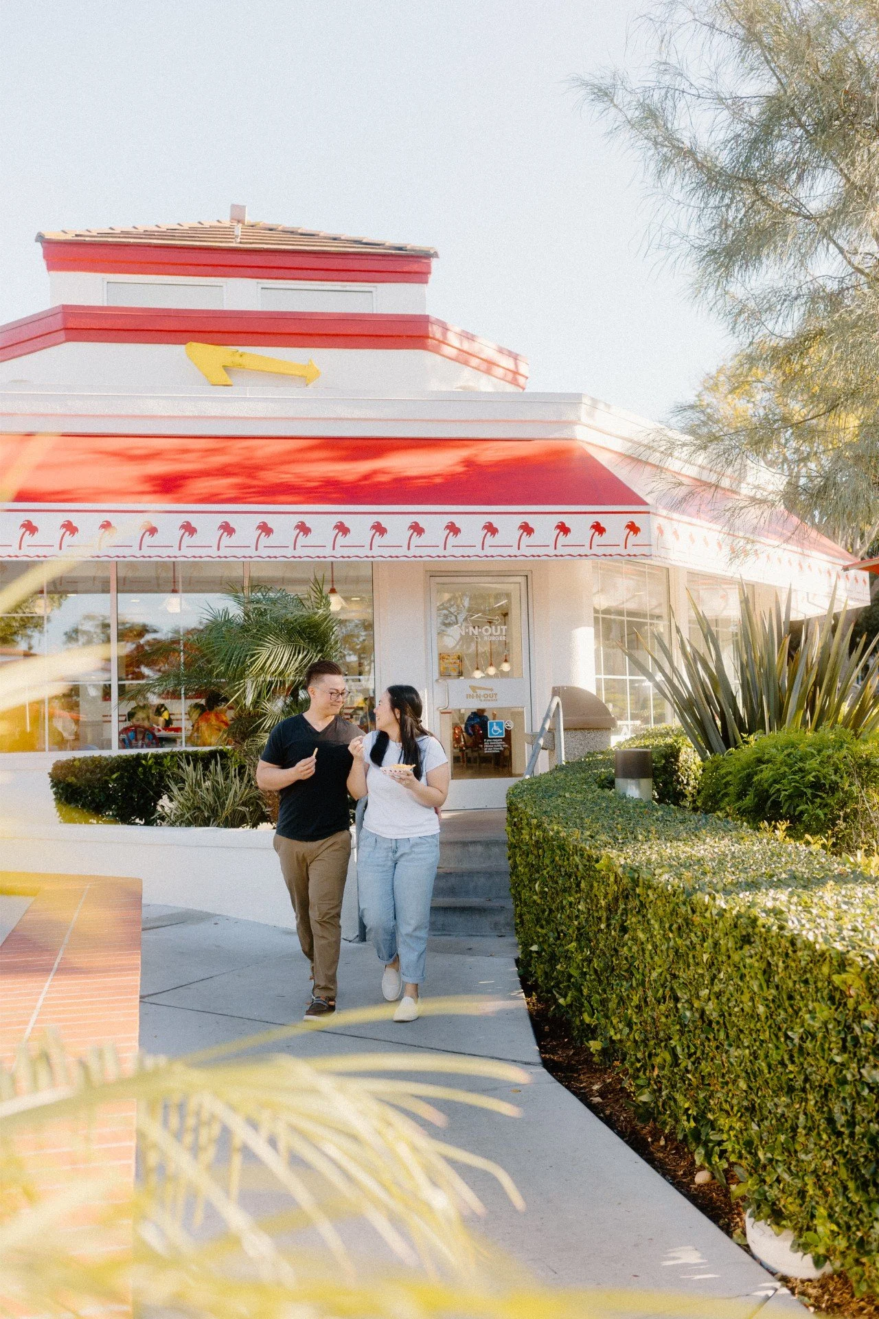 candid engagement photo of couple at in n out