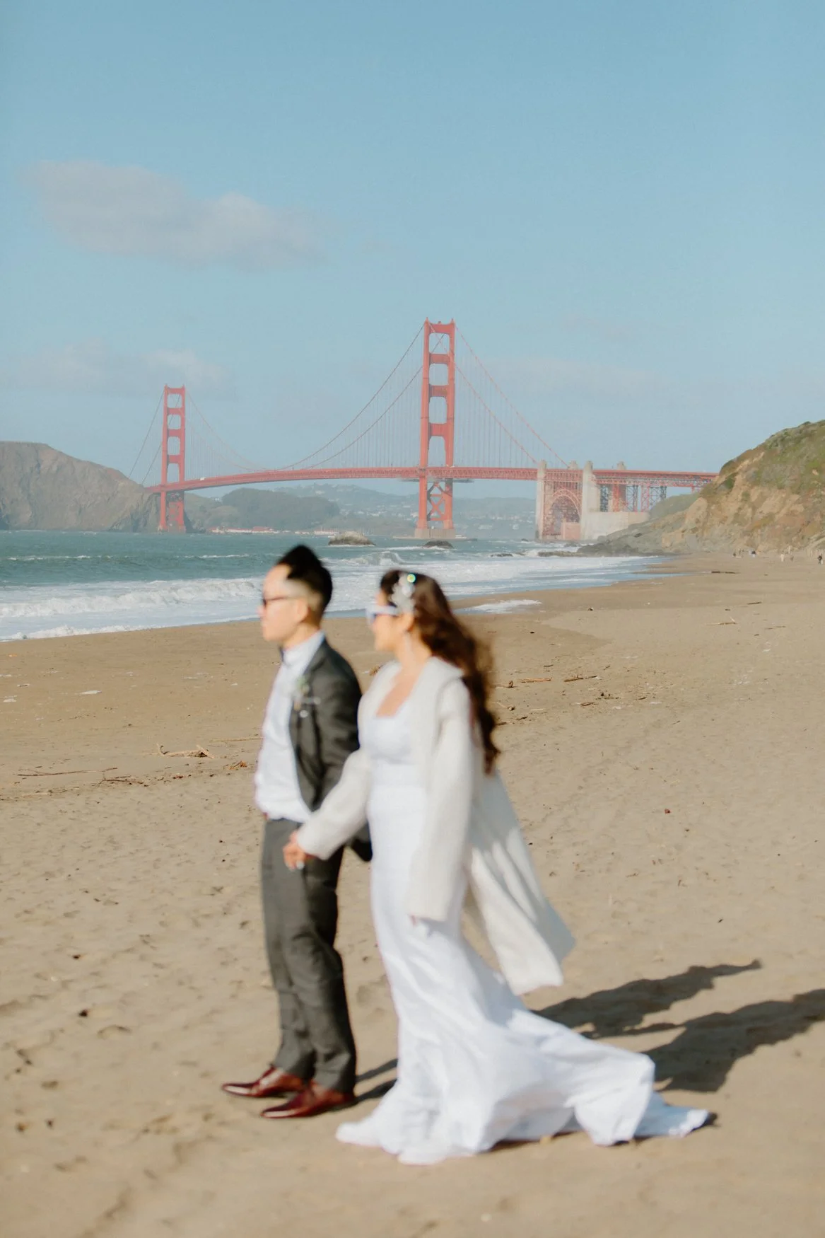Artful wedding portrait with Golden Gate Bridge background in San Francisco, CA by By Evening Photography
