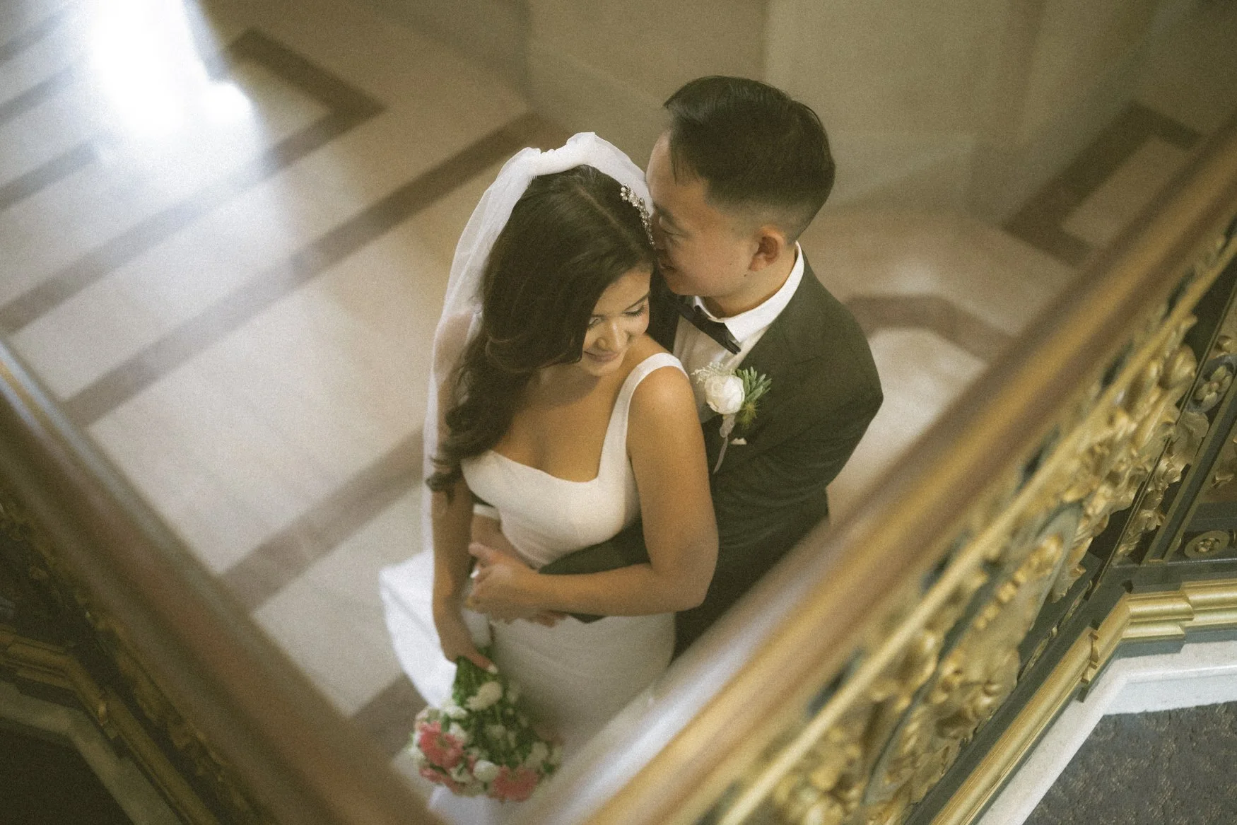 Jonathan whispers sweet nothings to Carla with San Francisco City Hall's detailed Hallways, in 35mm film