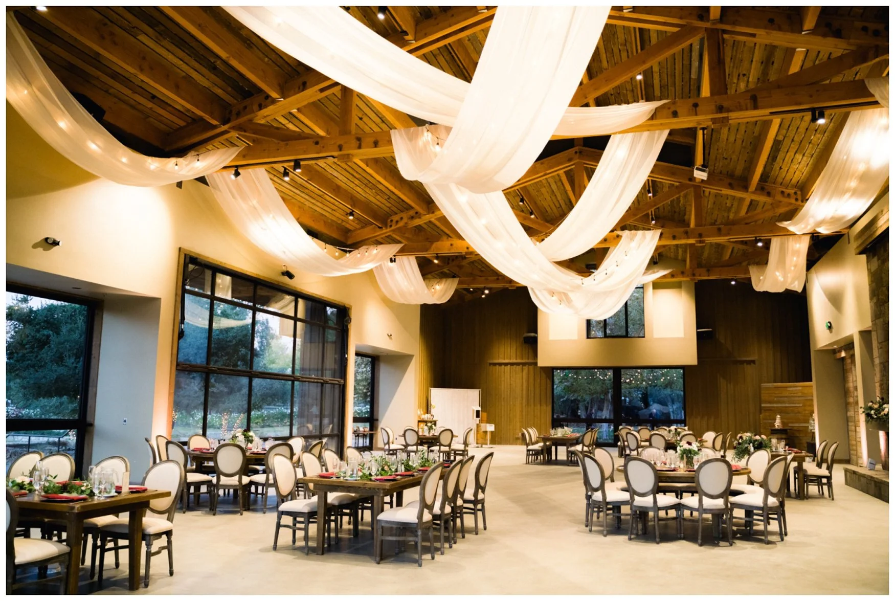 Galway Downs Reception Barn with modern wooden beams and elegant linen draped on the ceilings