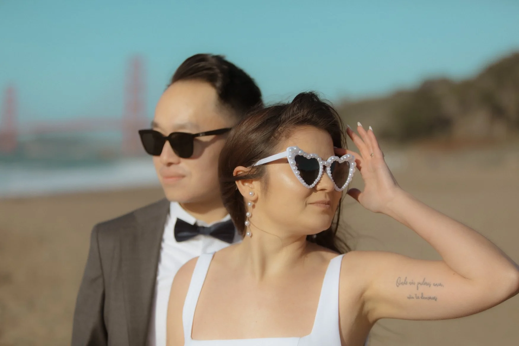 Fun Vintage wedding photo of Bride and Groom with their wedding sunnies in Baker Beach, CA by By Evening Photo and Films, Bay Area wedding and elopement photographer