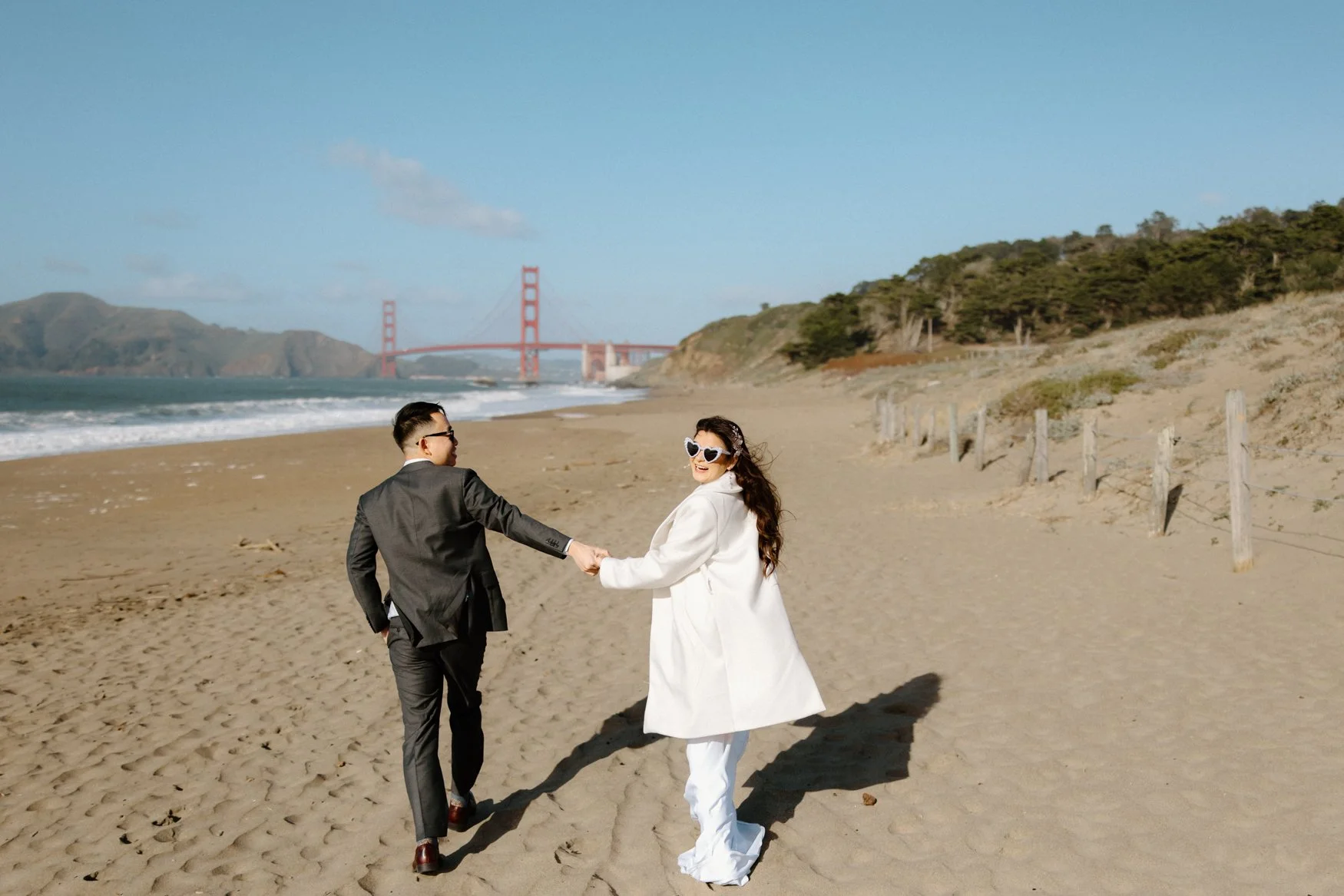 Candid moment of Jonathan and Carla laughing together at Baker Beach after their San Francisco City Hall wedding