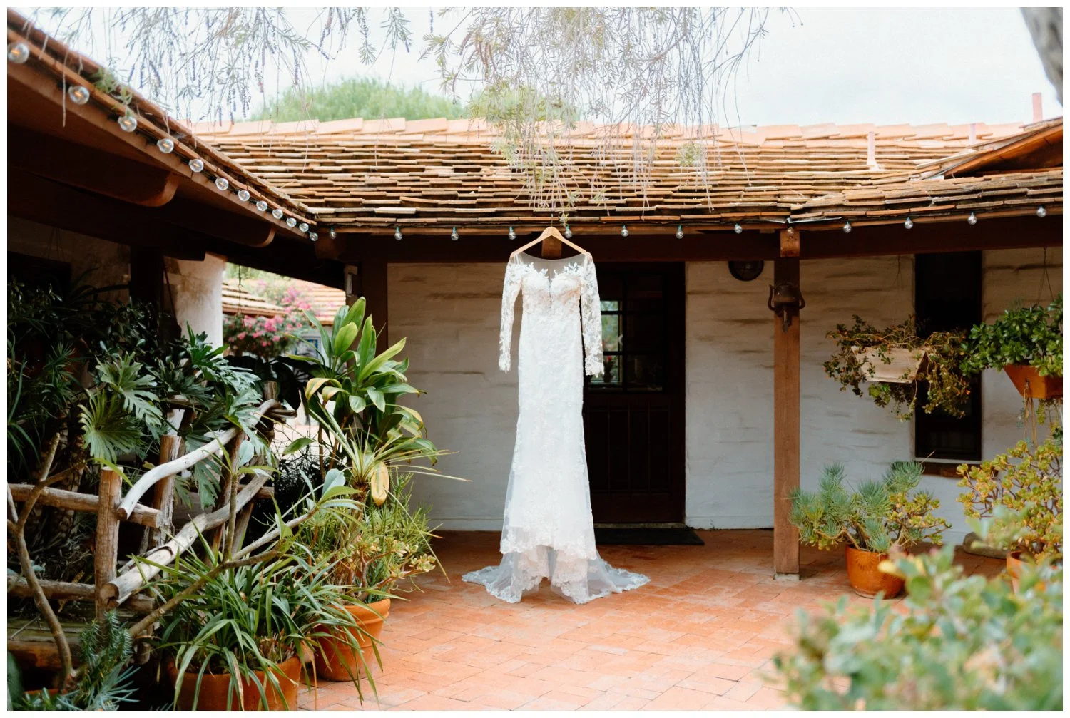 Boho Chic Wedding Dress Hanging in the Old Rancho Wedding Venue, overcast and natural wedding in Carlsbad, California