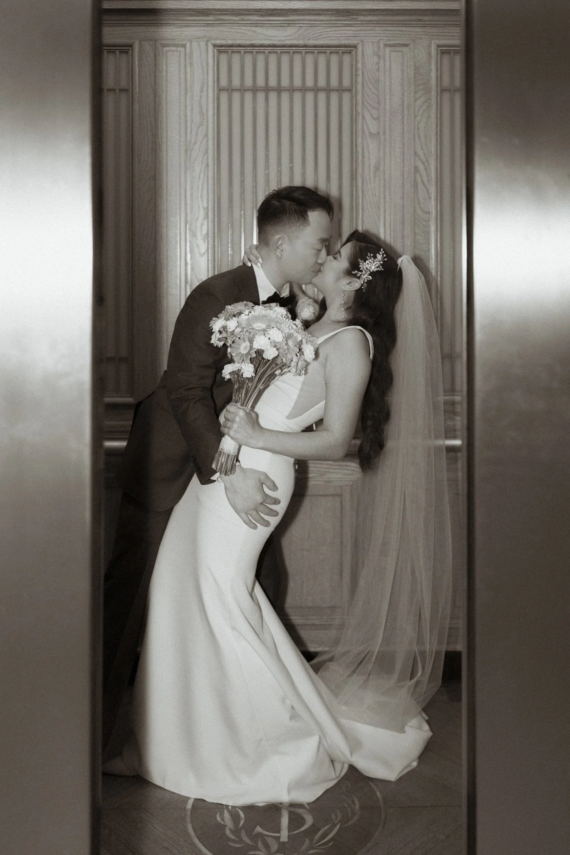 Jonathan dips Carla for a kiss in the iconic San Francisco City Hall elevator, romantic documentary wedding photo