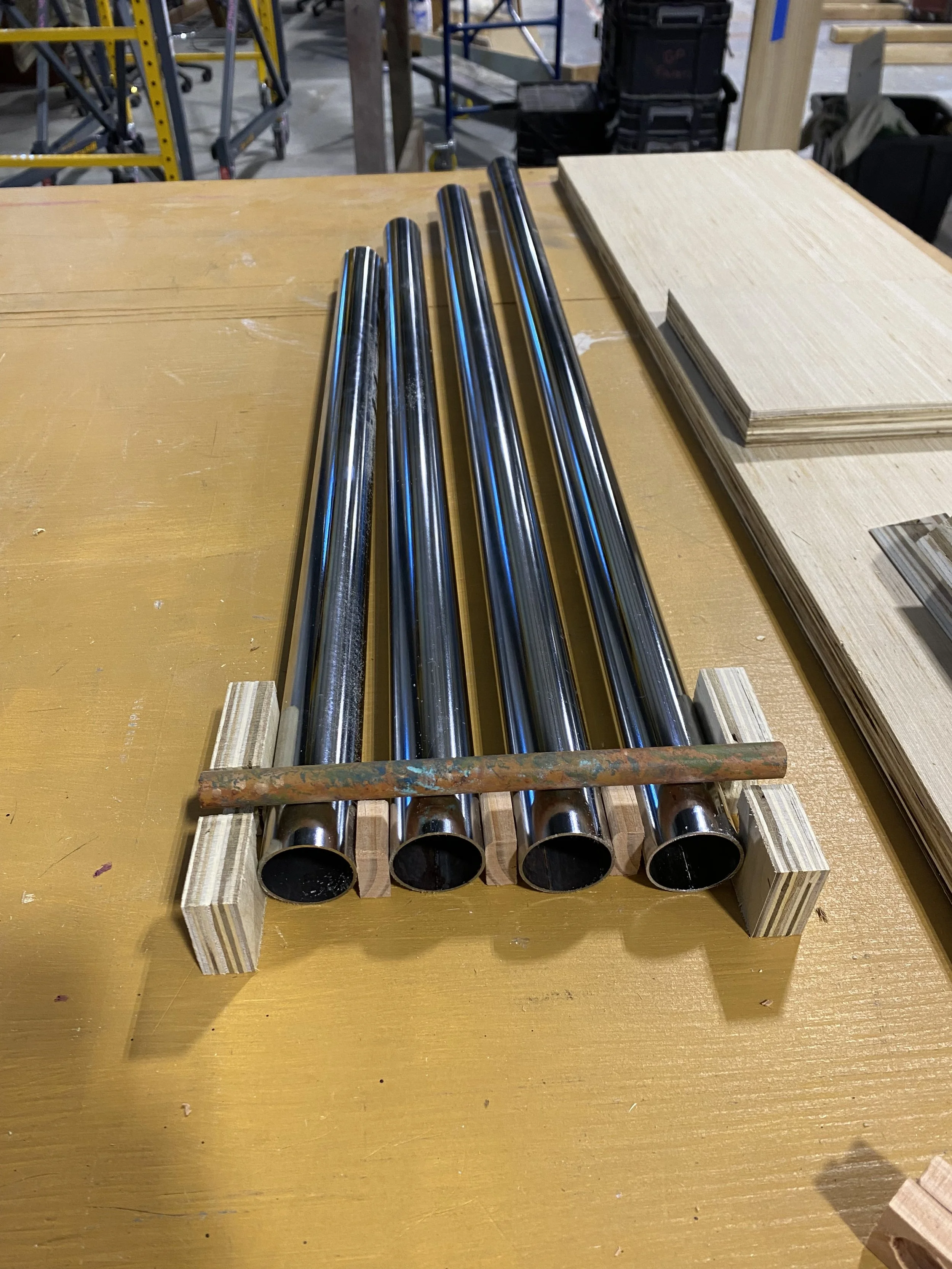 I needed a way for the chimes to hang but still be secure within the chime box. Upon research I found that the chimes in door chimes would not swing but the director of the play wanted these chimes to swing for a larger effect after they were hit by 