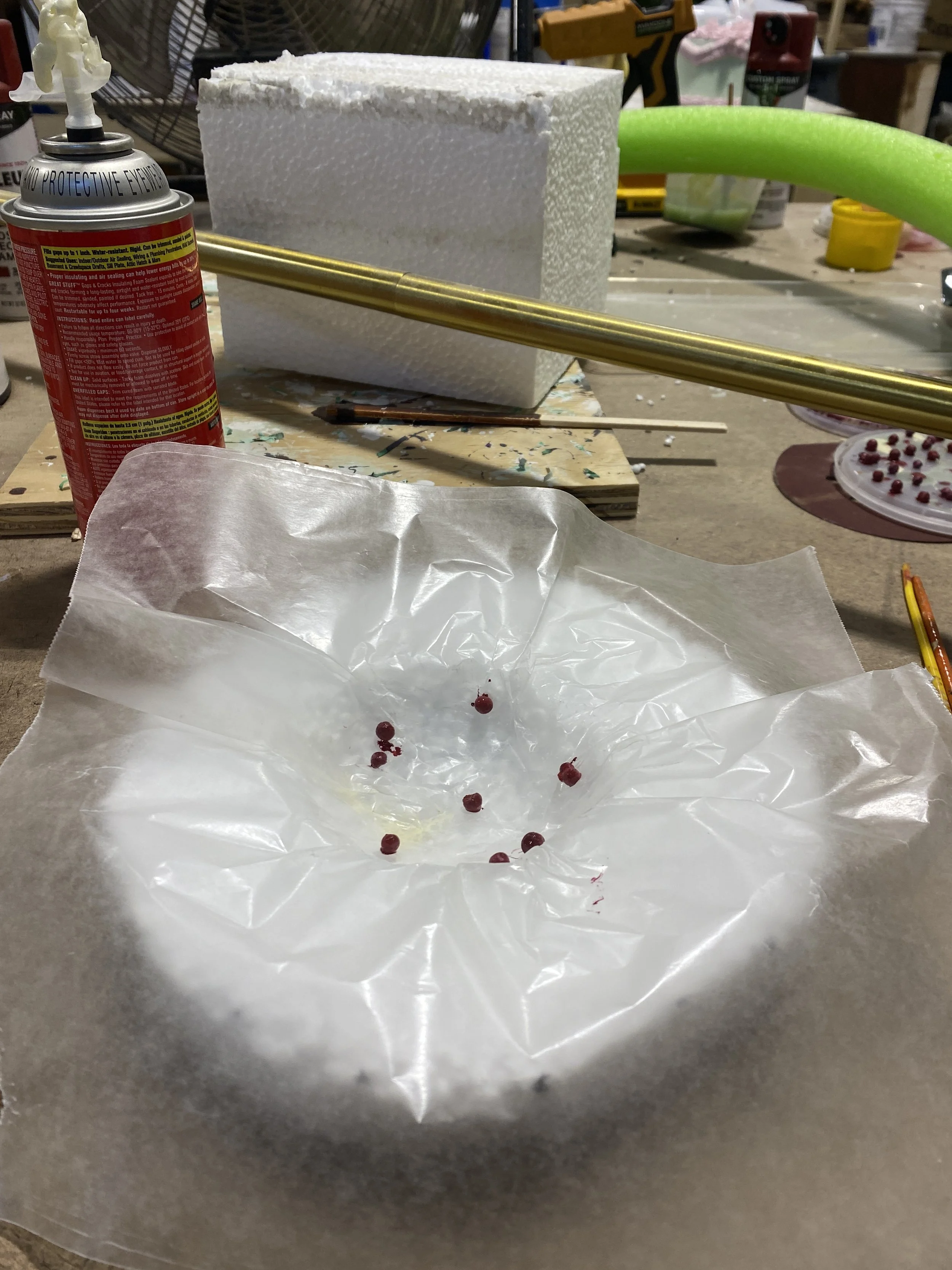I wanted the teacakes to be more realistic so I took the styrofoam I dug out for the mold and separated the individual balls into a container of watered down acrylic to make a berry texture for the teacakes before adding the spray foam to the mold