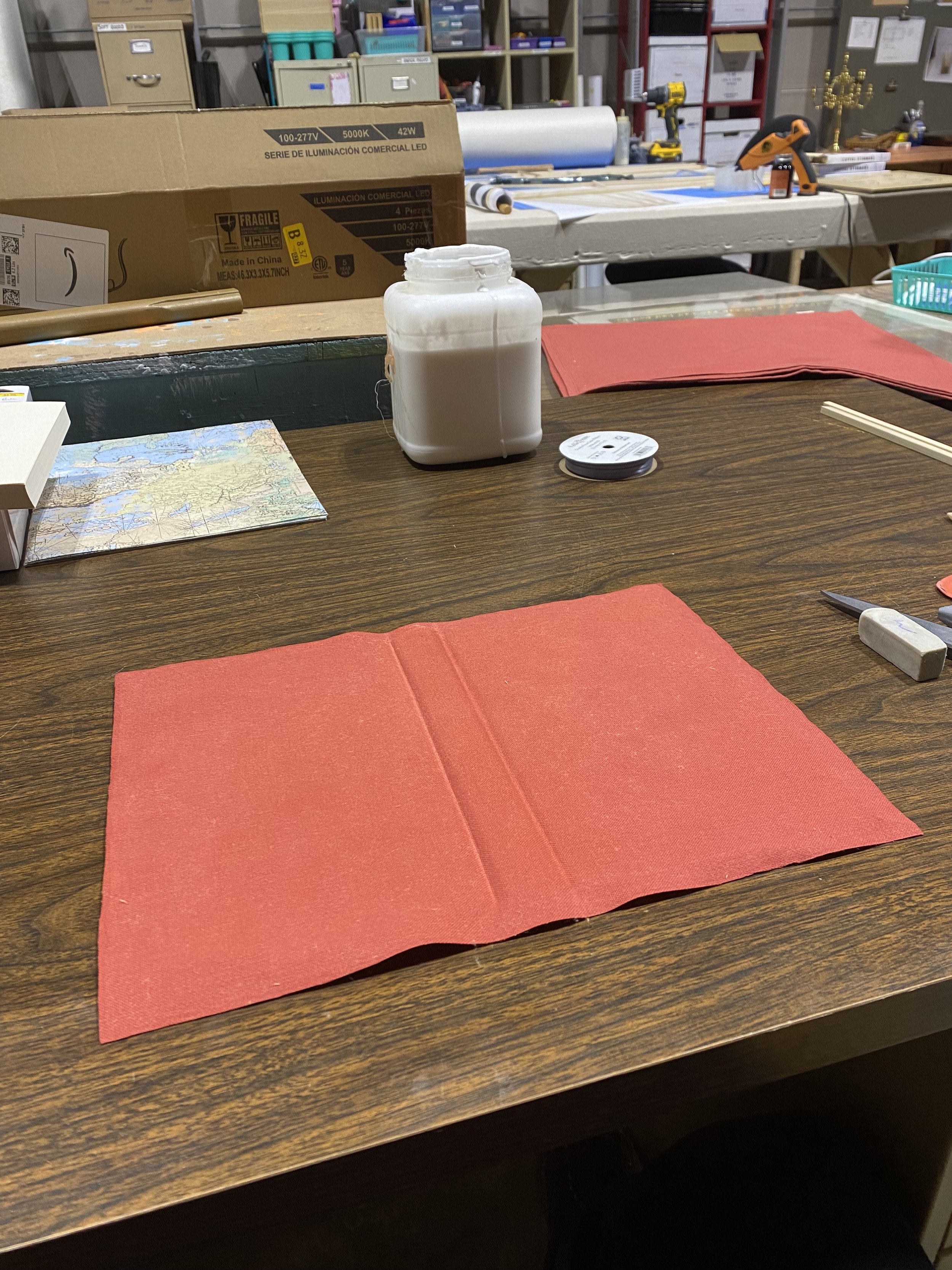 After cutting the fabric I glued the new cover onto a book that I took the pages out of- I would reinstall the pages later and add front and back binding pages made out of a map print scrapbooking paper