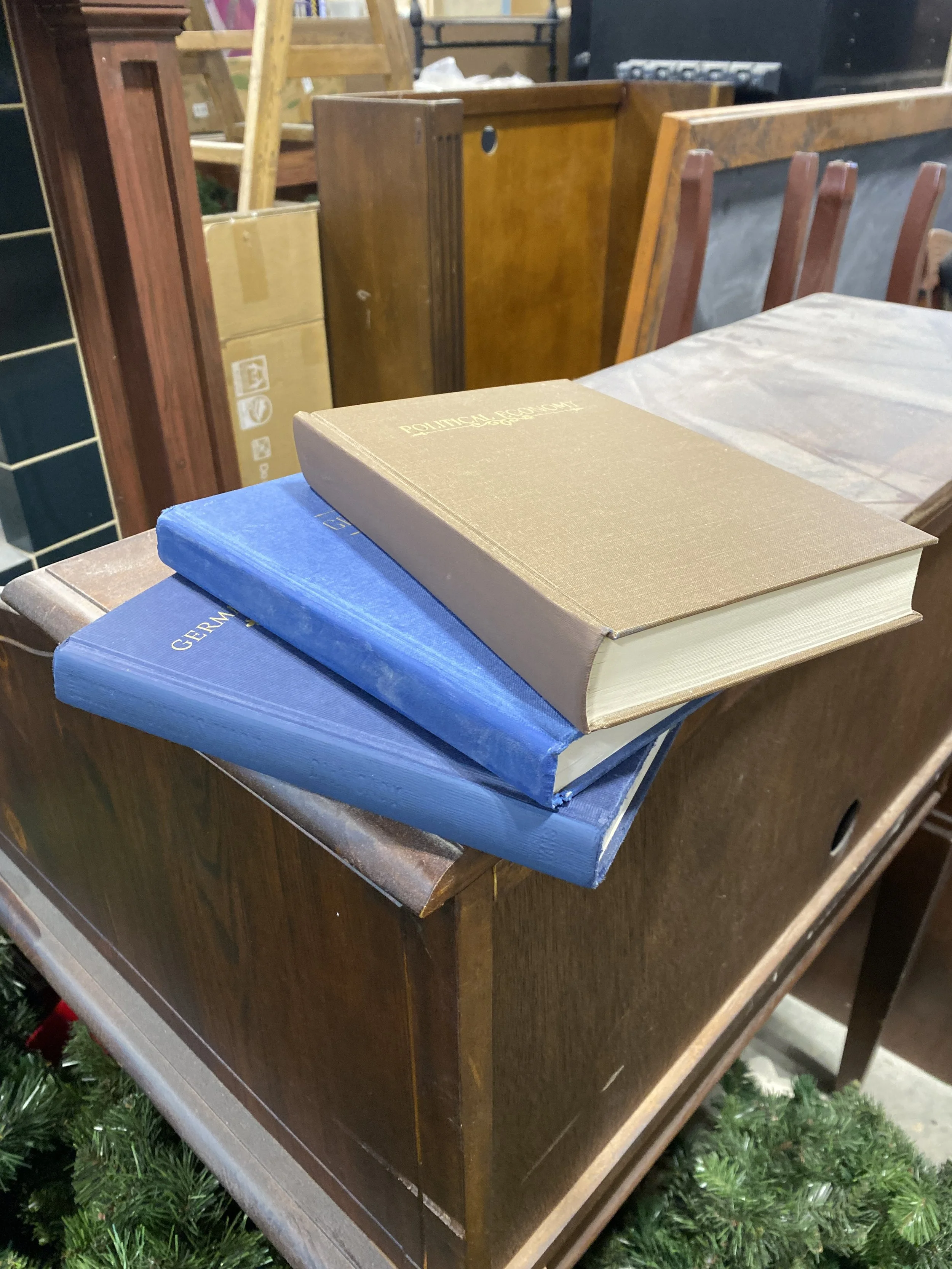 The three education books stacked with Cricut vinyl lettering and accents