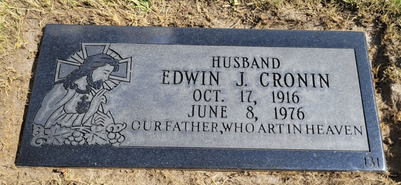 Gray grave marker with an image of Jesus praying and the inscription for Edwin J. Cronin, born October 17, 1916, died June 8, 1976, with the phrase 'Our Father, Who Art in Heaven'.