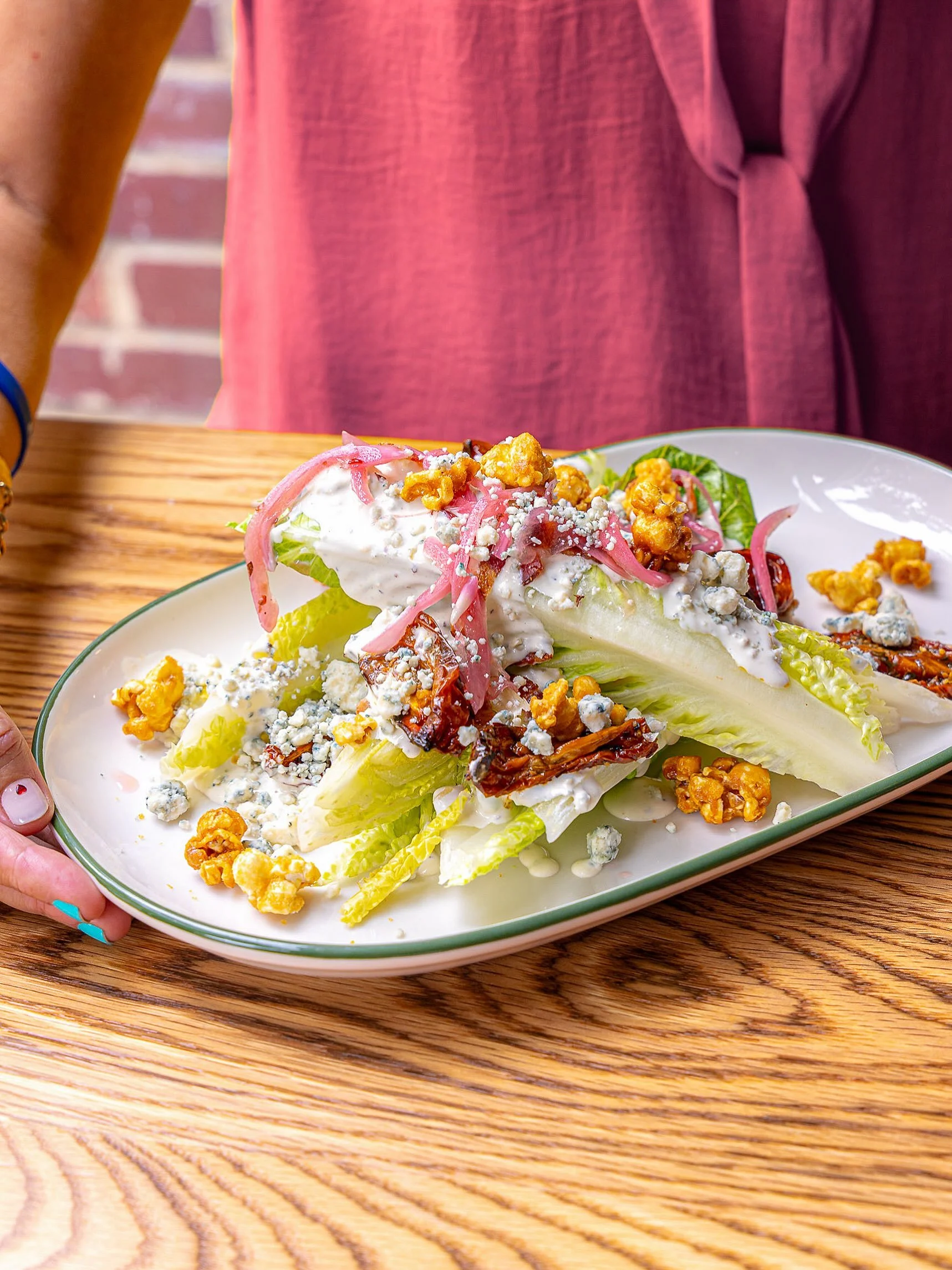 Who knew Cracker Jacks belonged on salad? 🥗 Our Romaine Wedge is brings the flavor with smokehouse bacon, roasted Roma tomatoes, blue cheese crumbles, pickled red onions, &ldquo;Peanuts and Cracker Jacks,&rdquo; 🍿 and our house blue cheese dressing