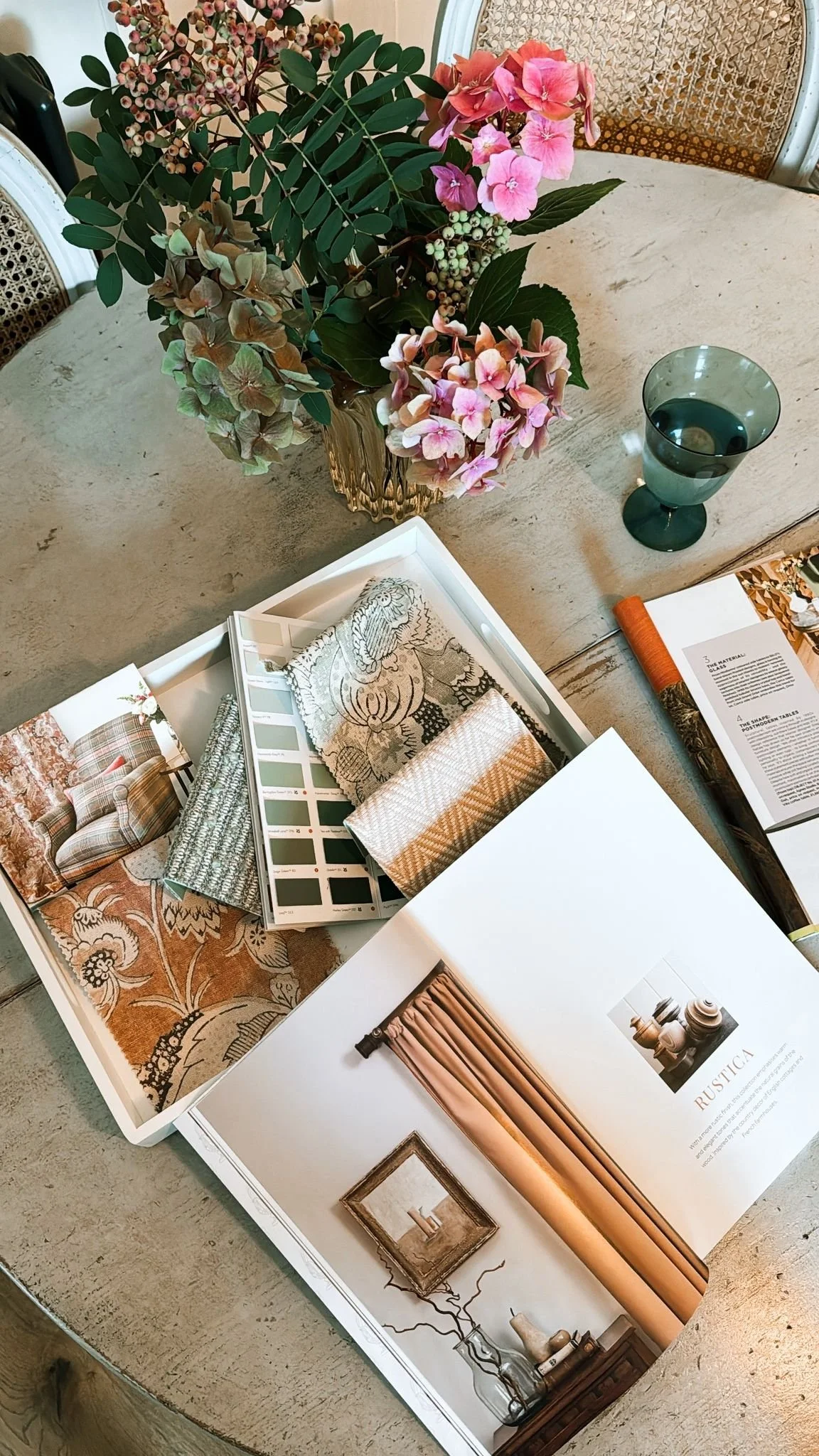 A selection of interior design brochures set upon a dining room table.