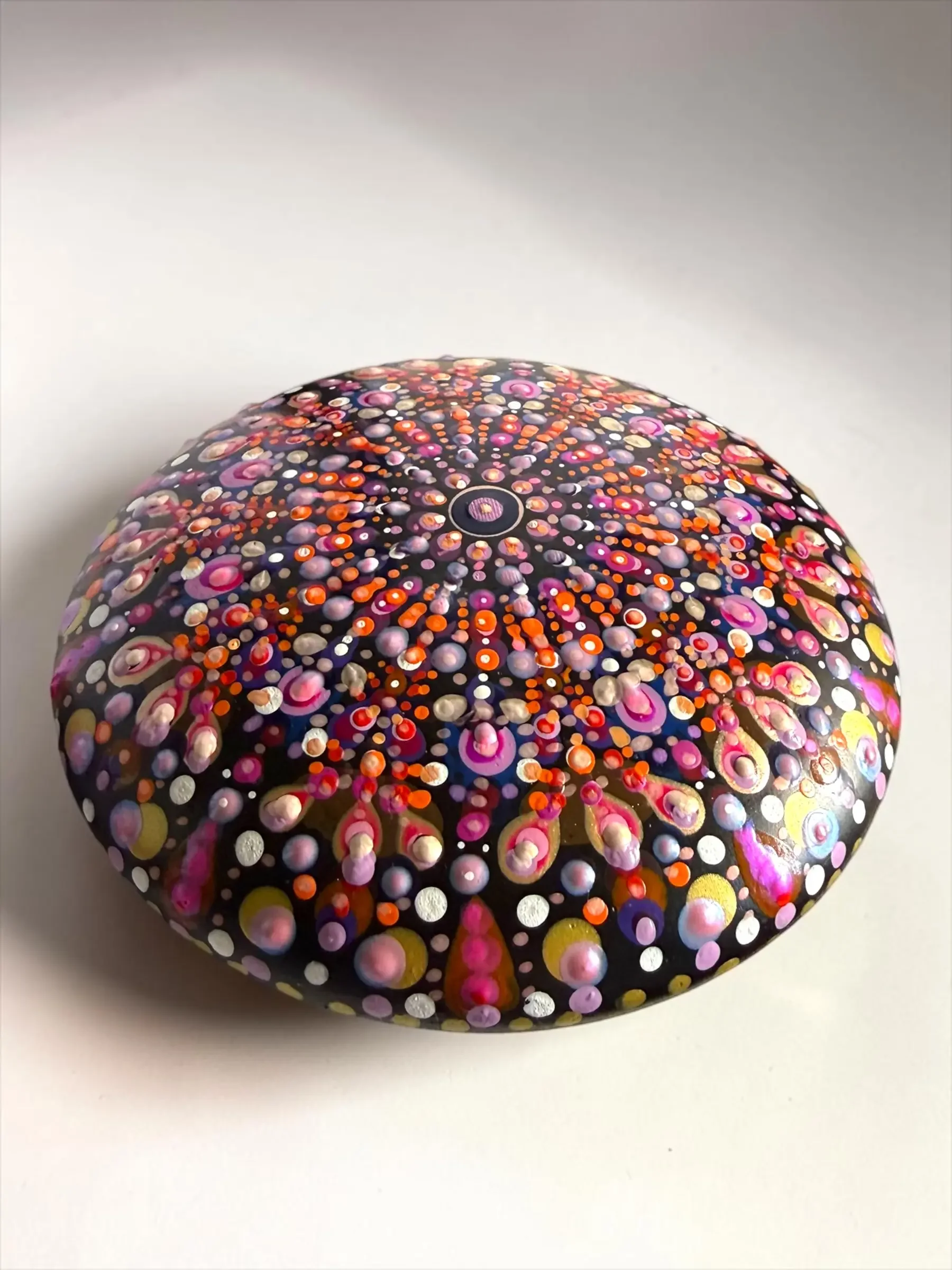 Large Mandala Stone featuring UV-reactive dot mandala artwork in orange, white, pink, and purple.