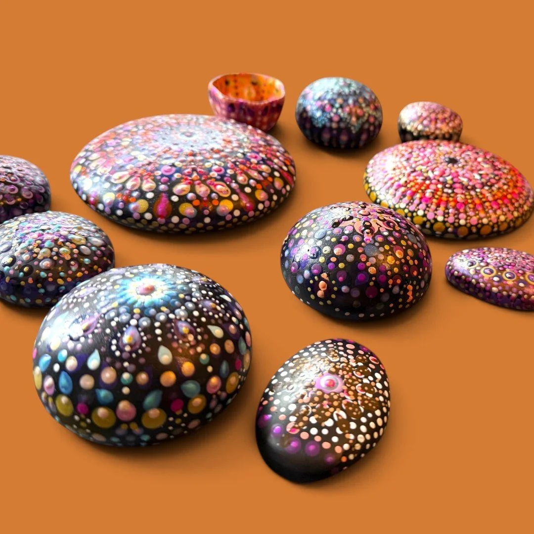 A display of different shaped and sized Mandala Stones made by Color Cult.
